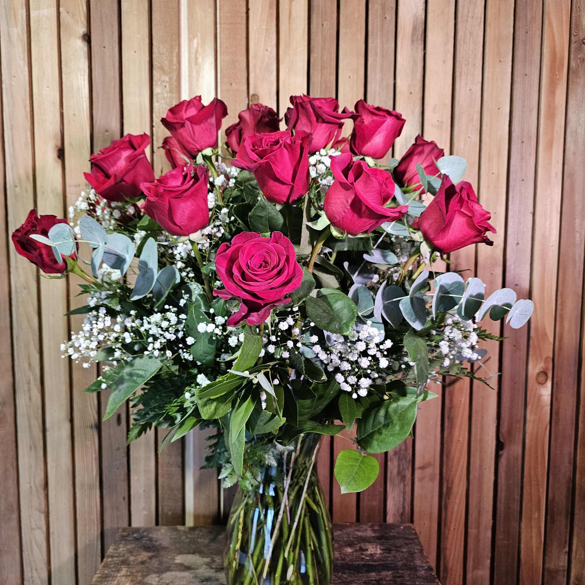 Bouquet of hot pink roses in a clear glass vase