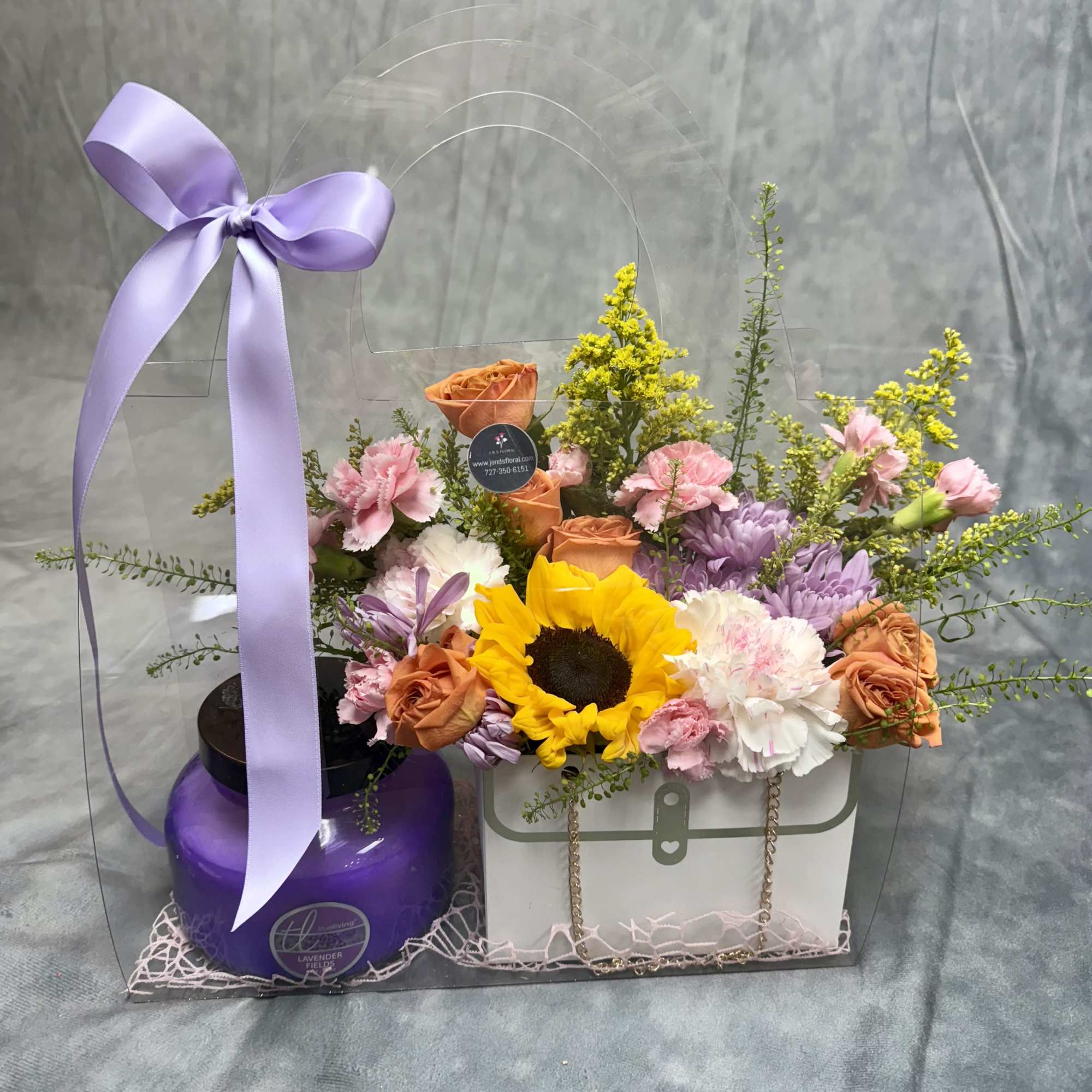 Flower gift set with sunflowers, roses, and carnations in a clear bag