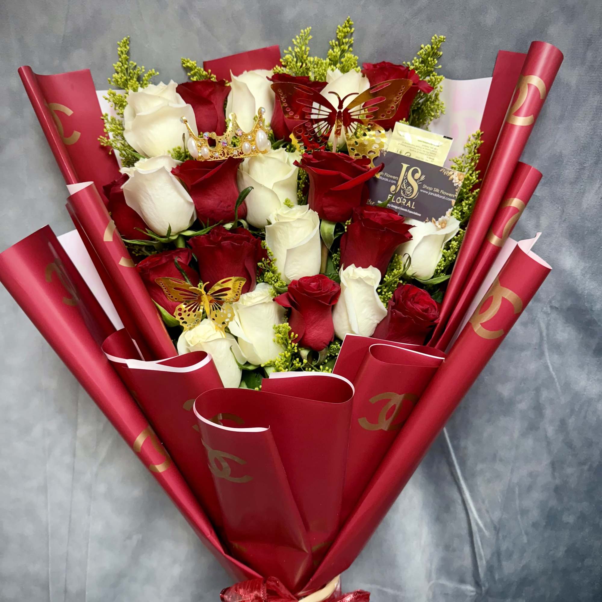 Bouquet of red and white roses wrapped in red paper
