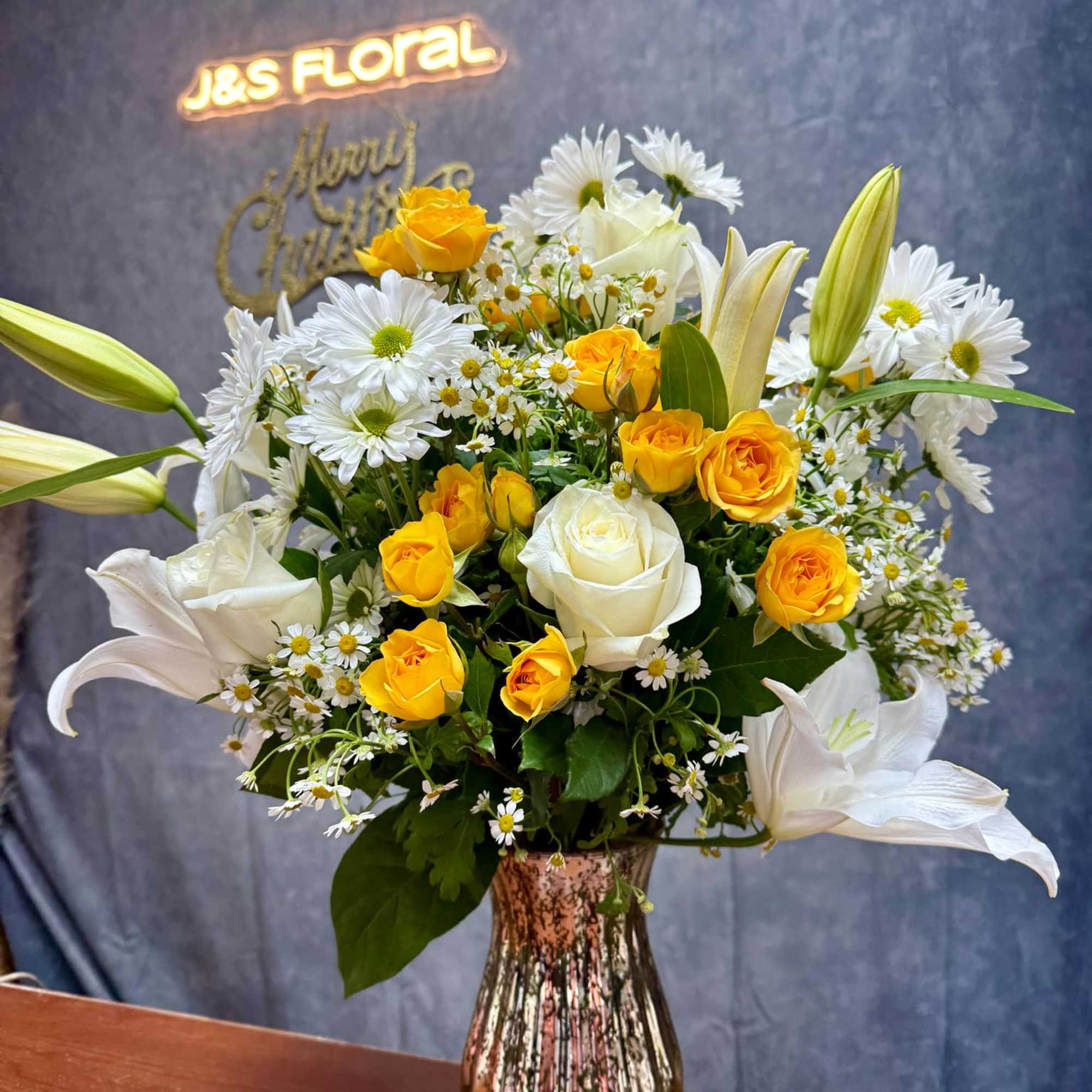 Brighten any day with our handcrafted Sunny Elegance floral arrangements, perfect for