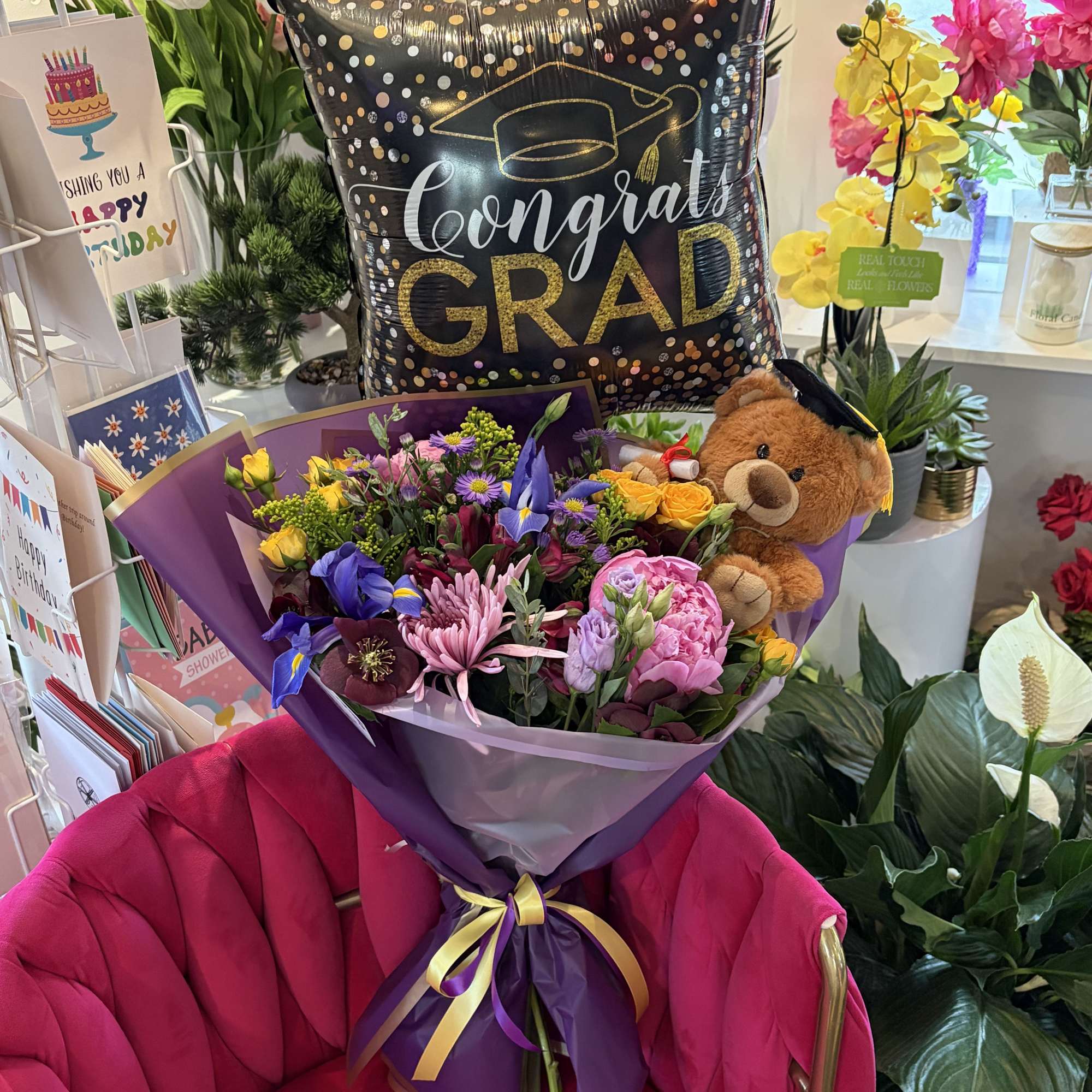 Bursting with jubilant color and celebratory flair, this graduation flower arrangement is