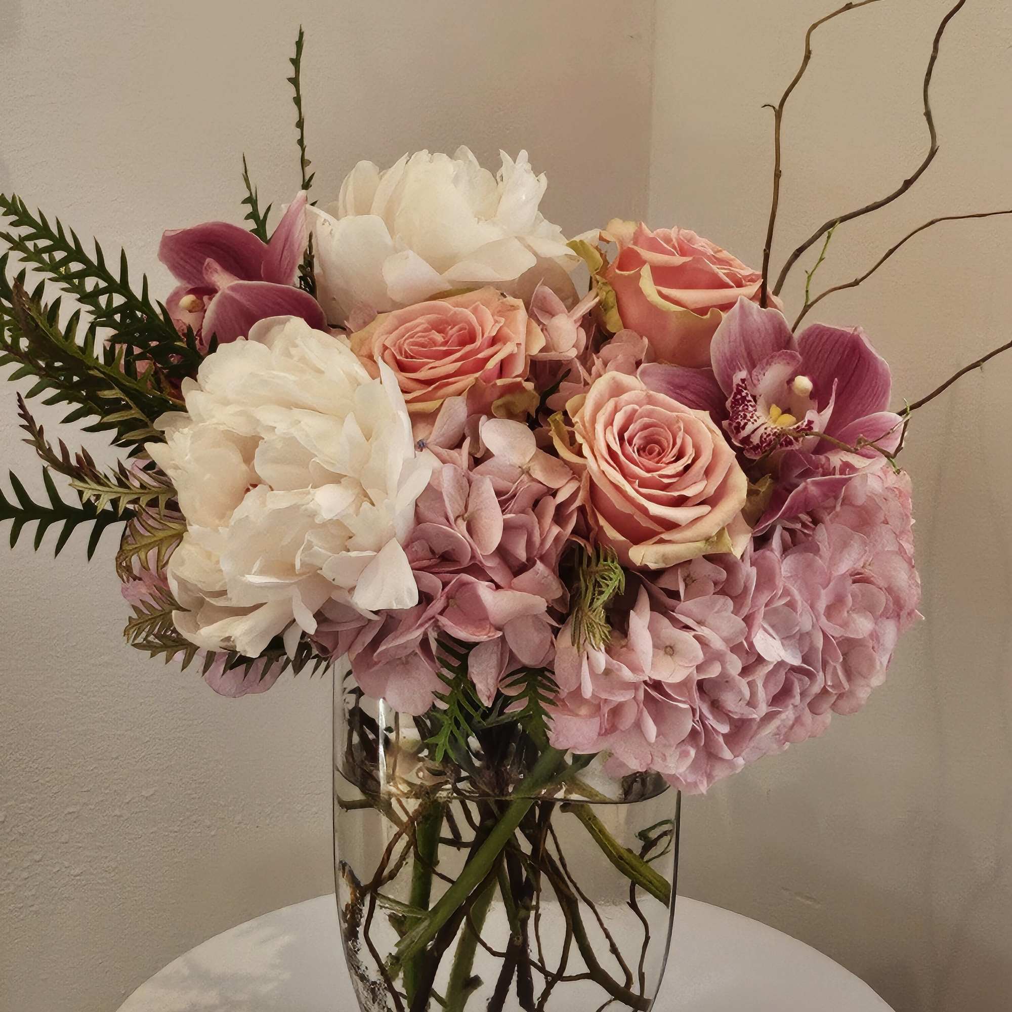 Pink and white floral arrangement in a clear glass vase
