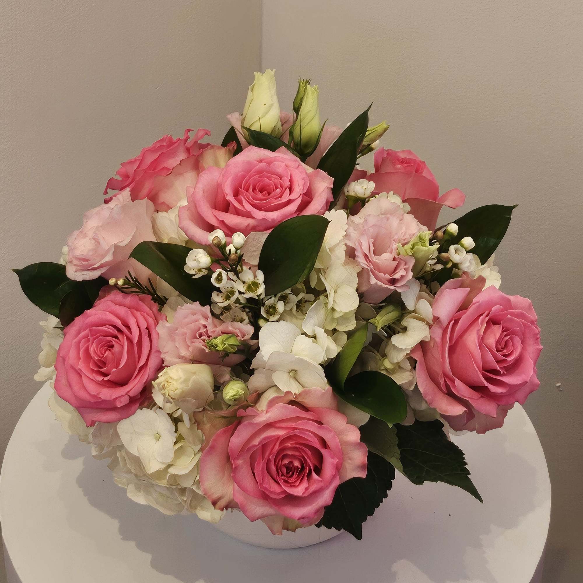 Pink rose bouquet with white hydrangea in a white vase