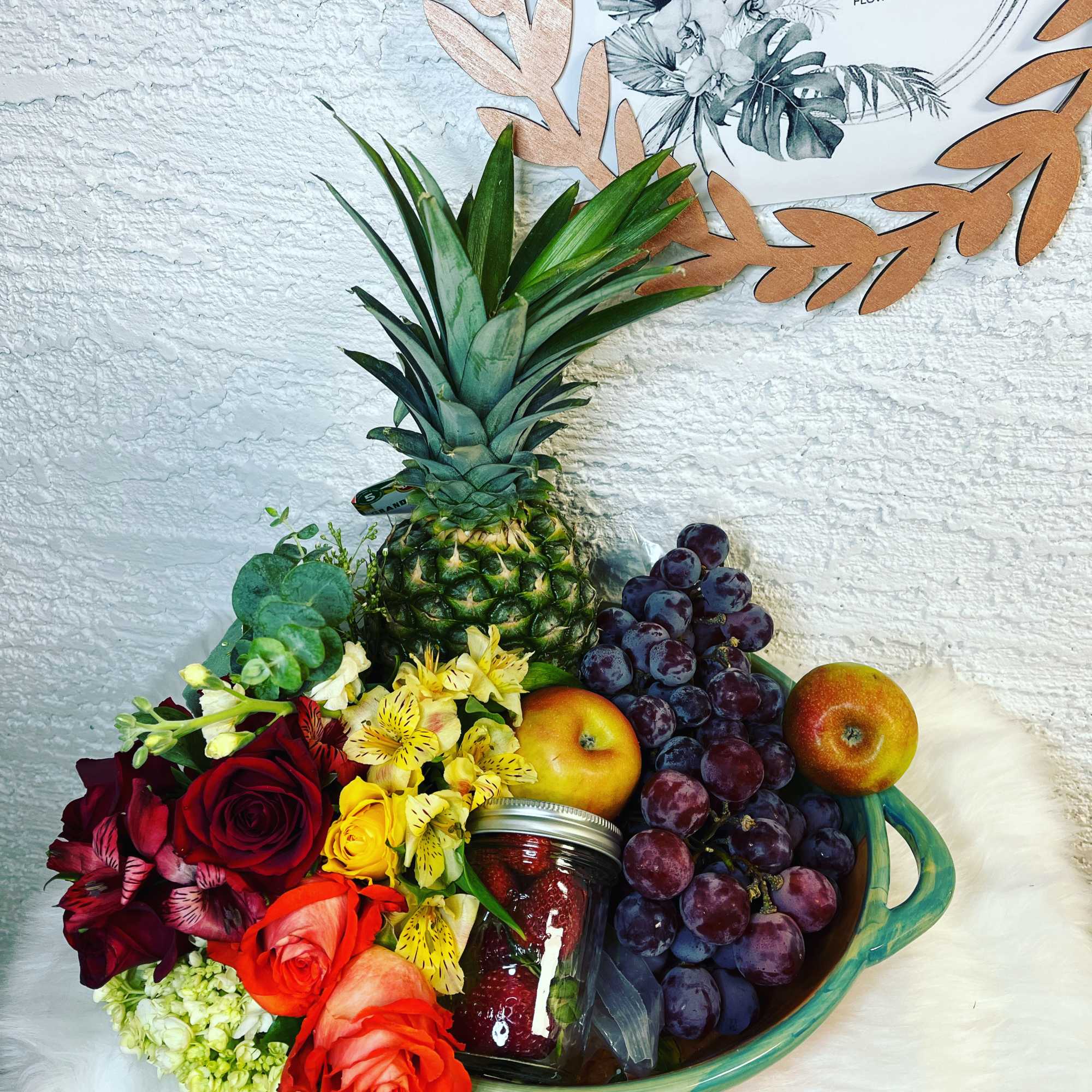Fruit basket with roses and a pineapple centerpiece