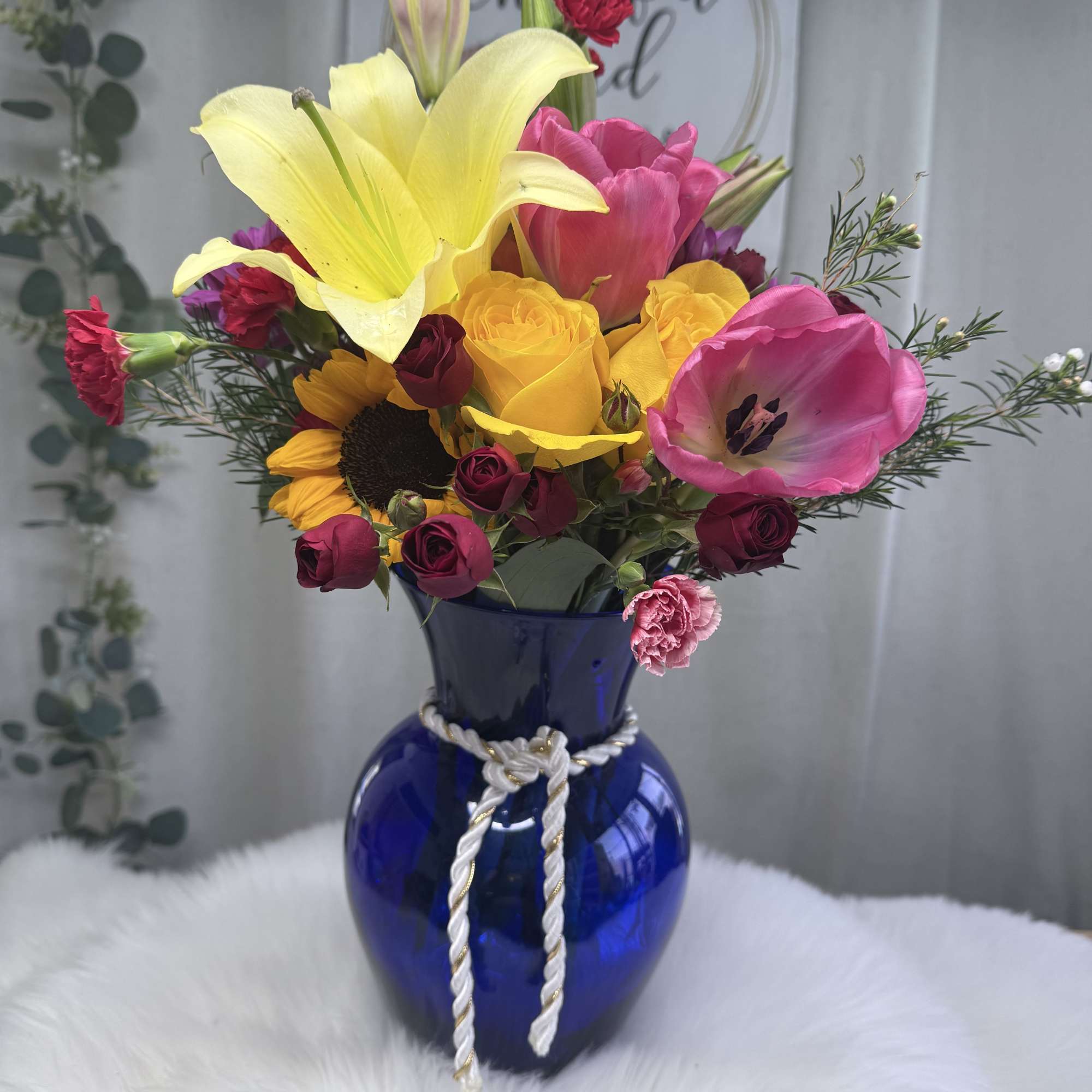 A lively and elegant floral arrangement bursting with seasonal color and charm.