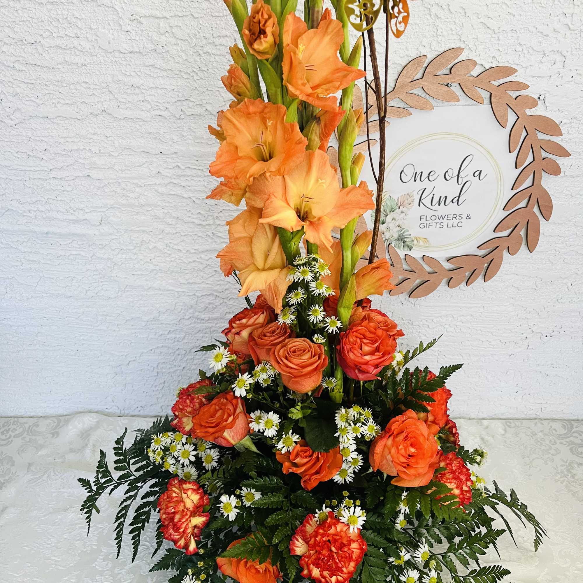 Tall orange floral arrangement with roses and gladiolus