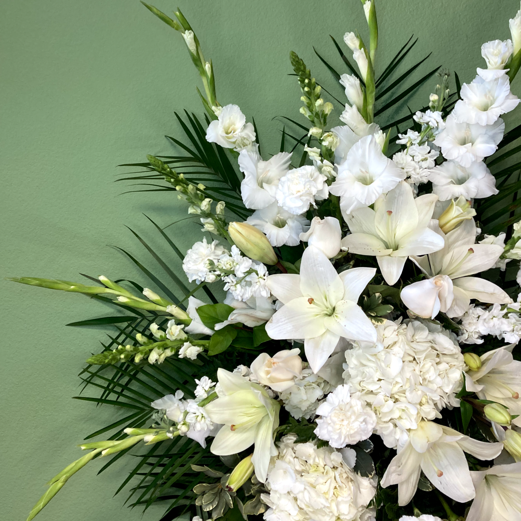 A serene standing spray of flowers that arrives delivered on an easel