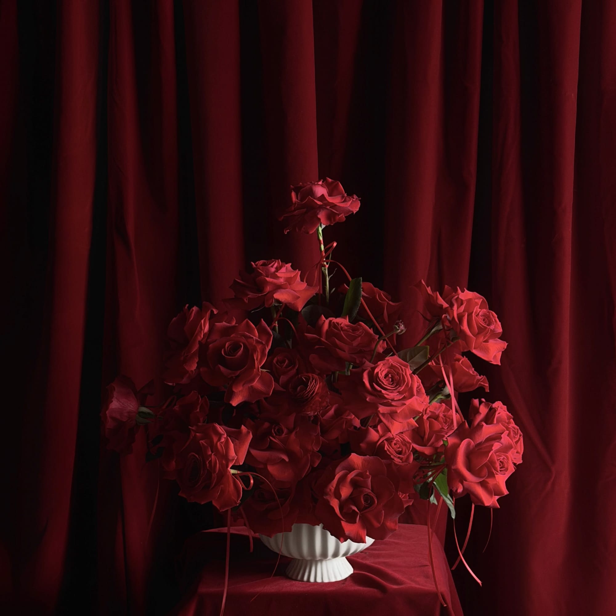 Designed for falling in love.
Layers of red roses and ranunculus,
wrapped in pure