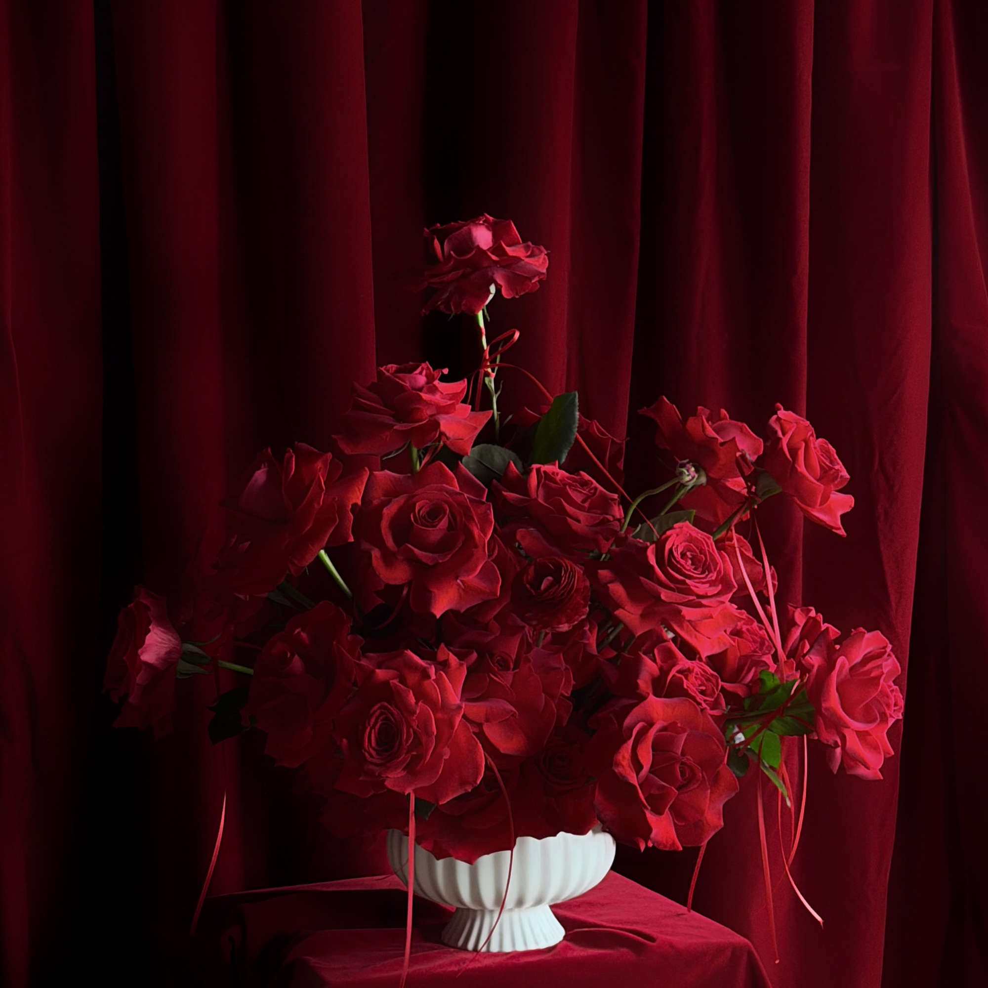 Designed for falling in love.
Layers of red roses and ranunculus,
wrapped in pure
