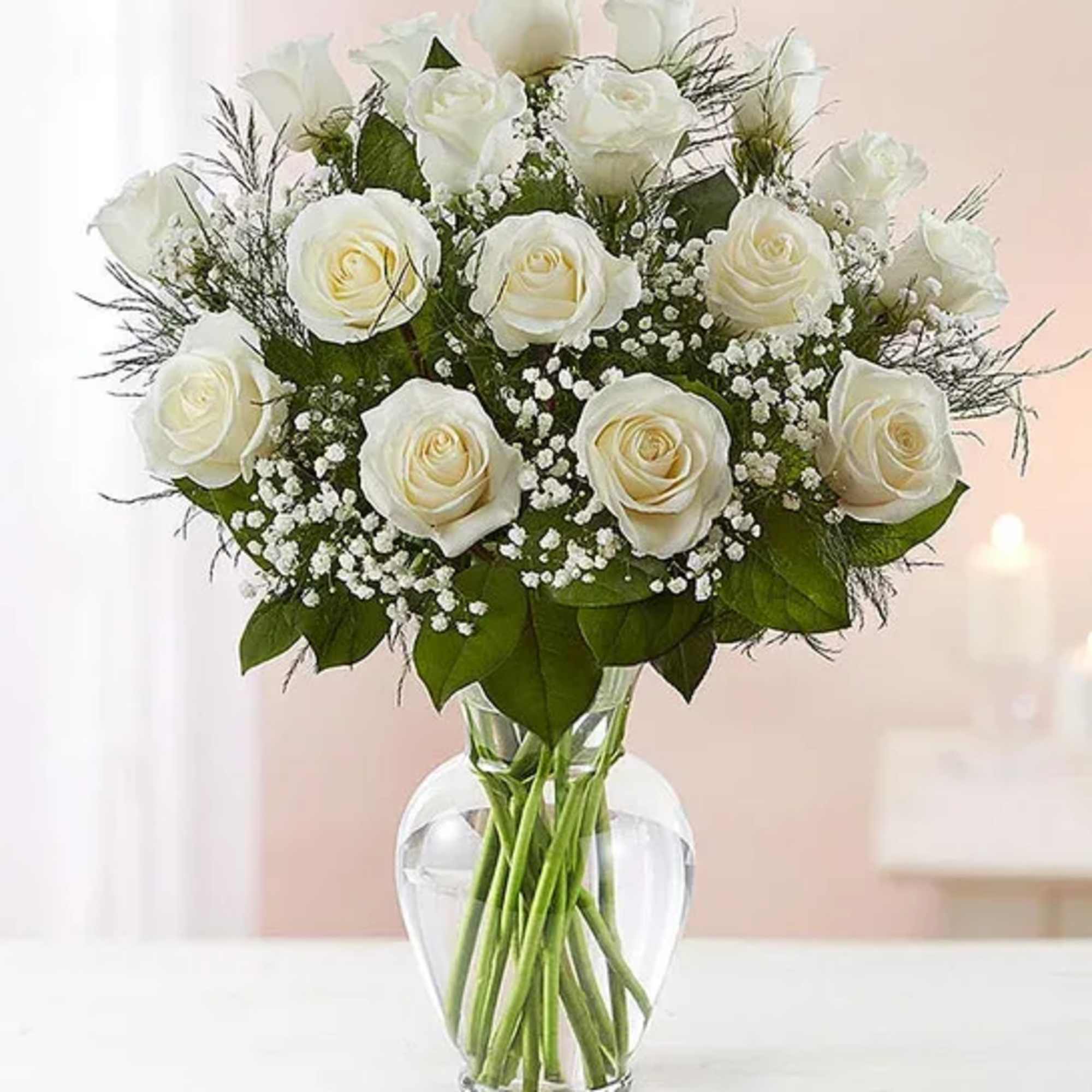 White roses arranged in a clear glass vase