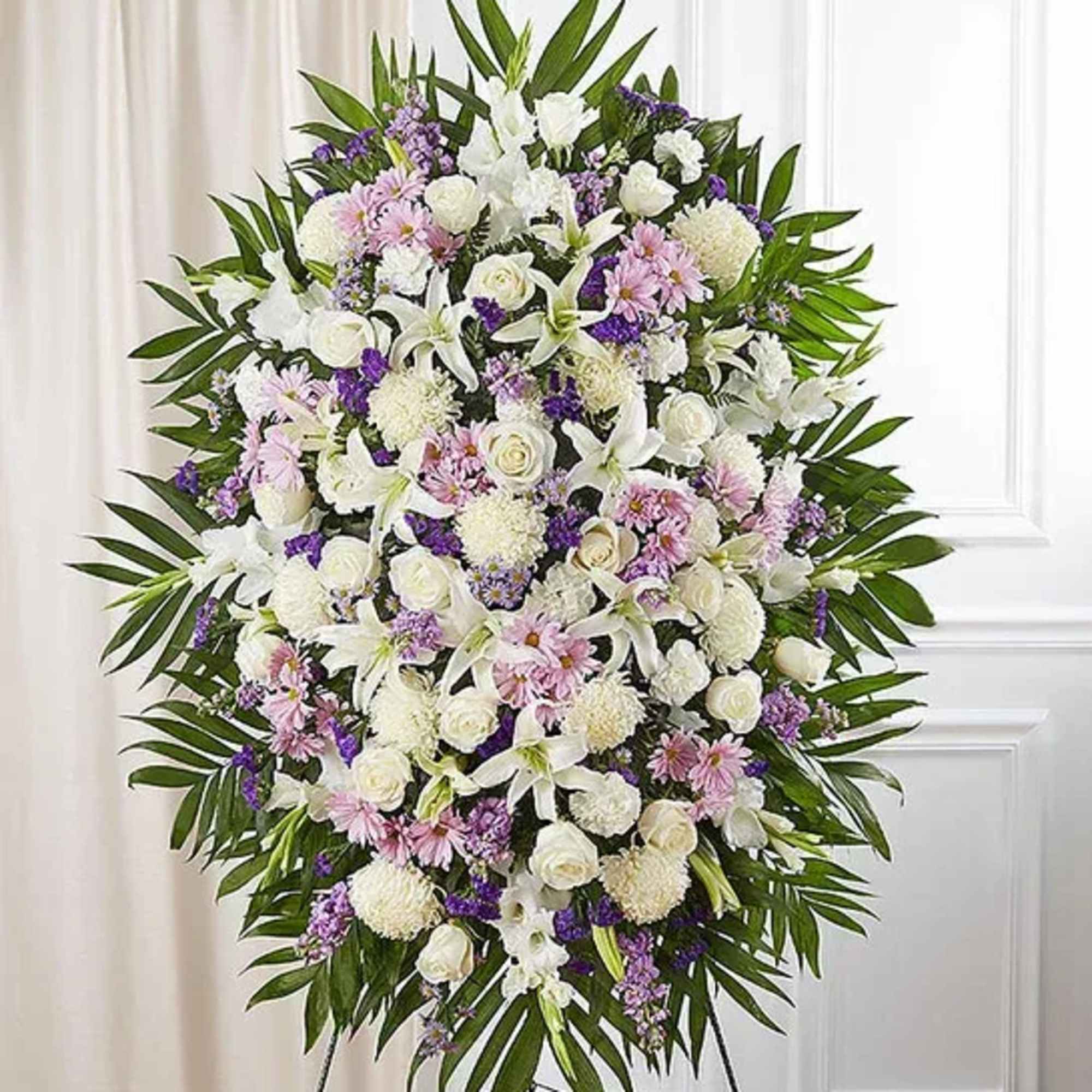 Large standing spray of white, pink, and purple flowers on a frame