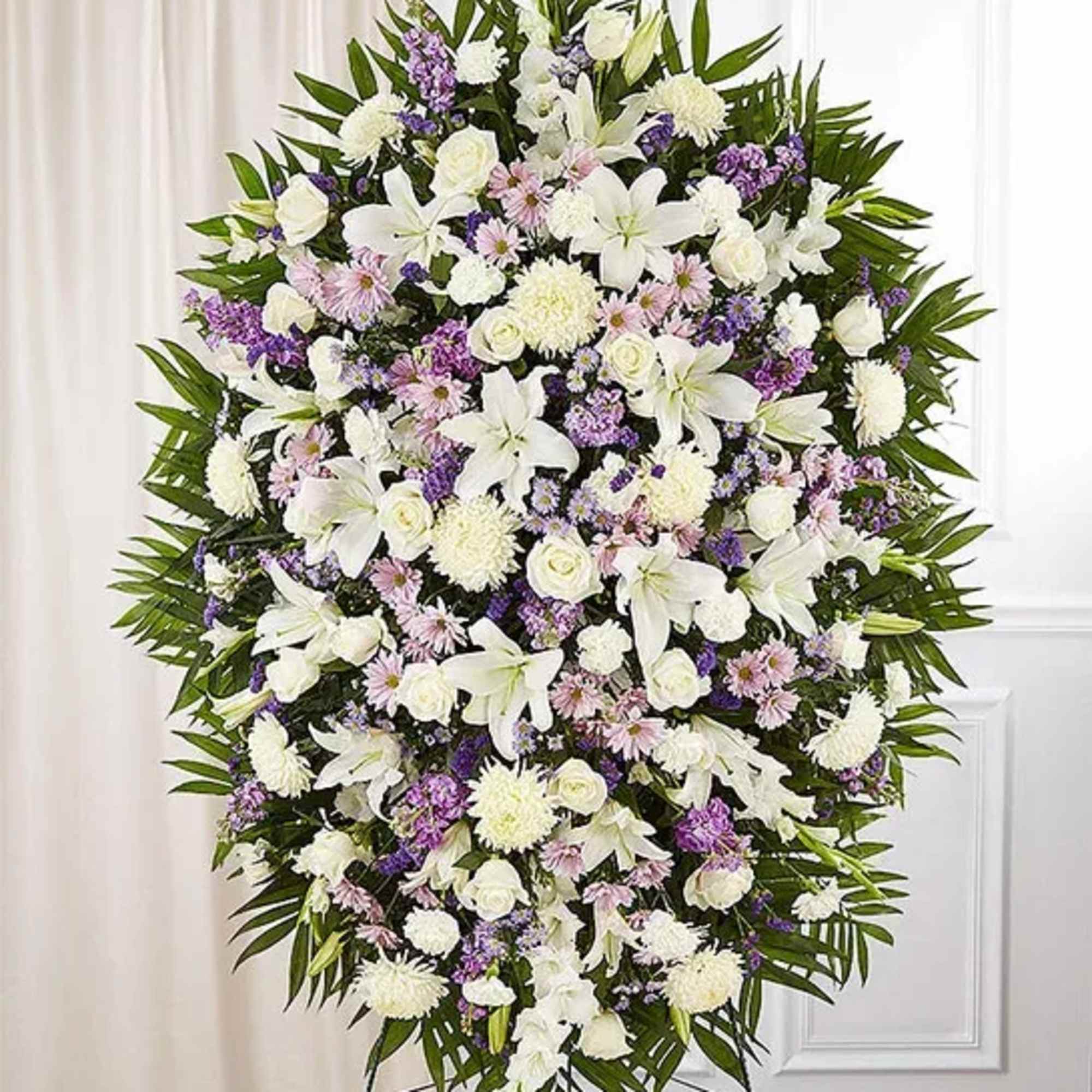 Large standing spray of white and lavender flowers on an easel