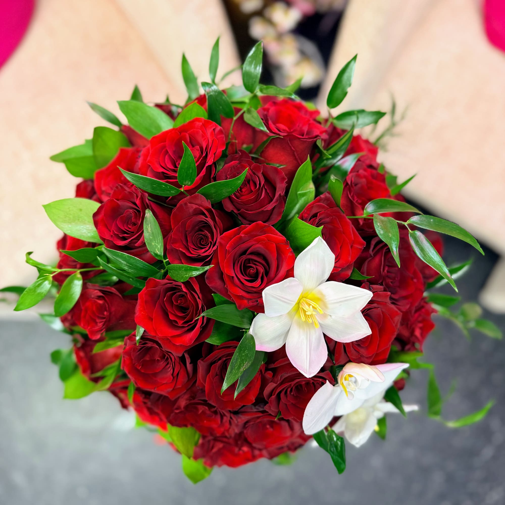 Bouquet of red roses with white lilies and greenery