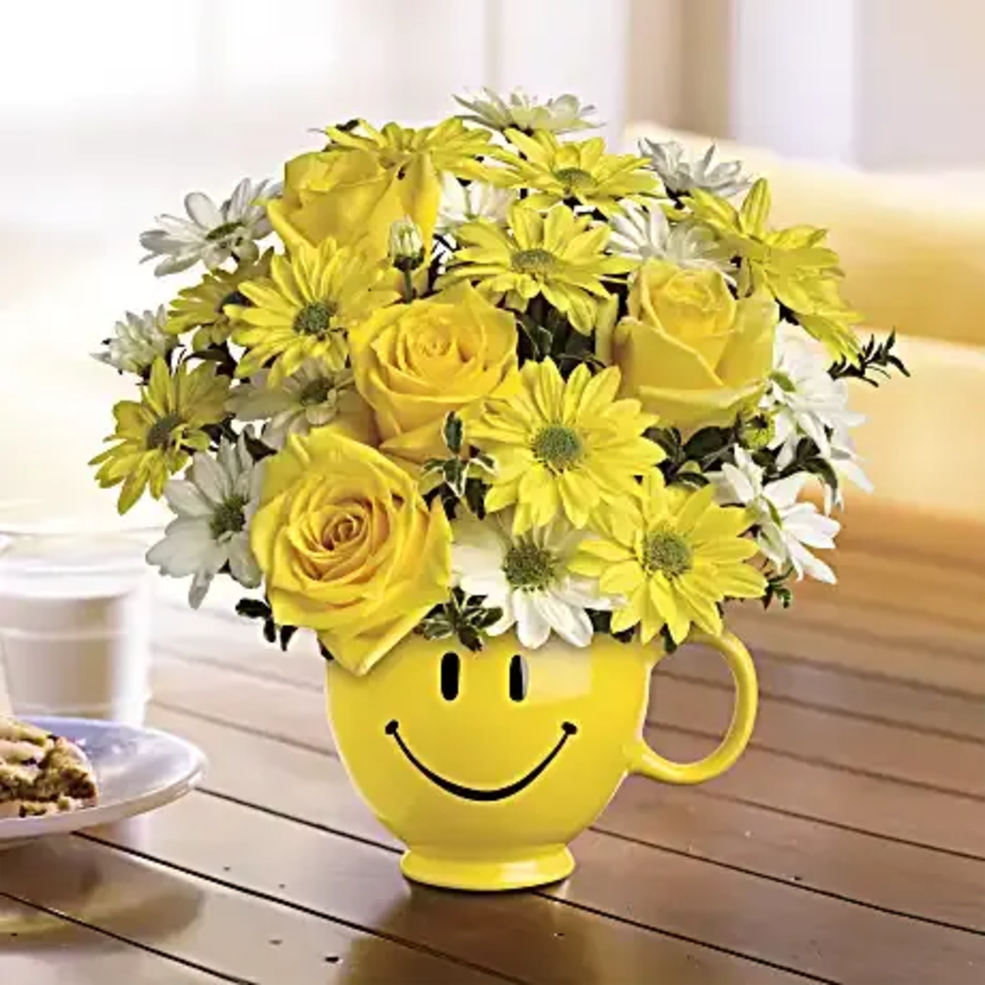Yellow roses and daisies in a smiley-face mug