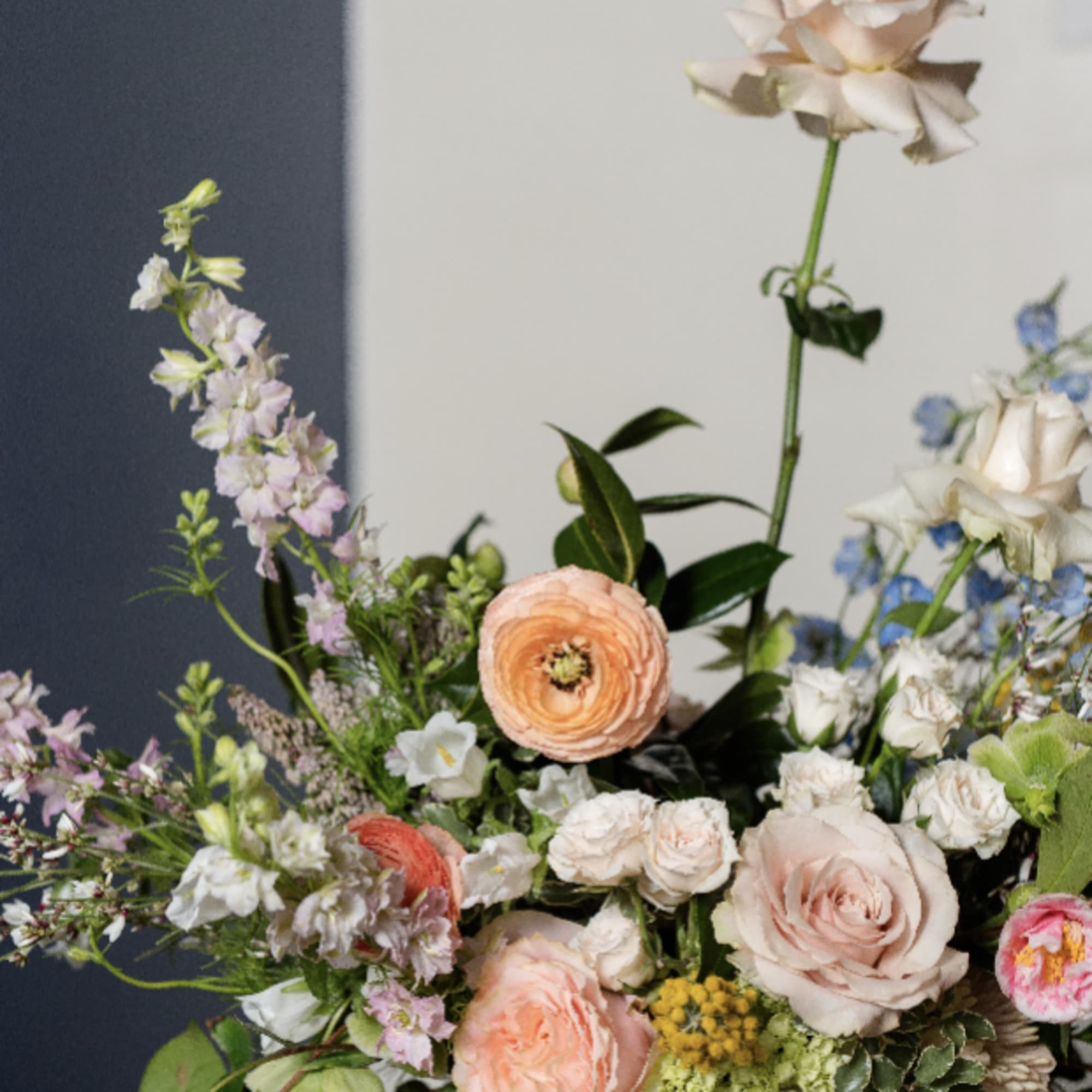 Mixed pastel flower arrangement in a low bowl vase