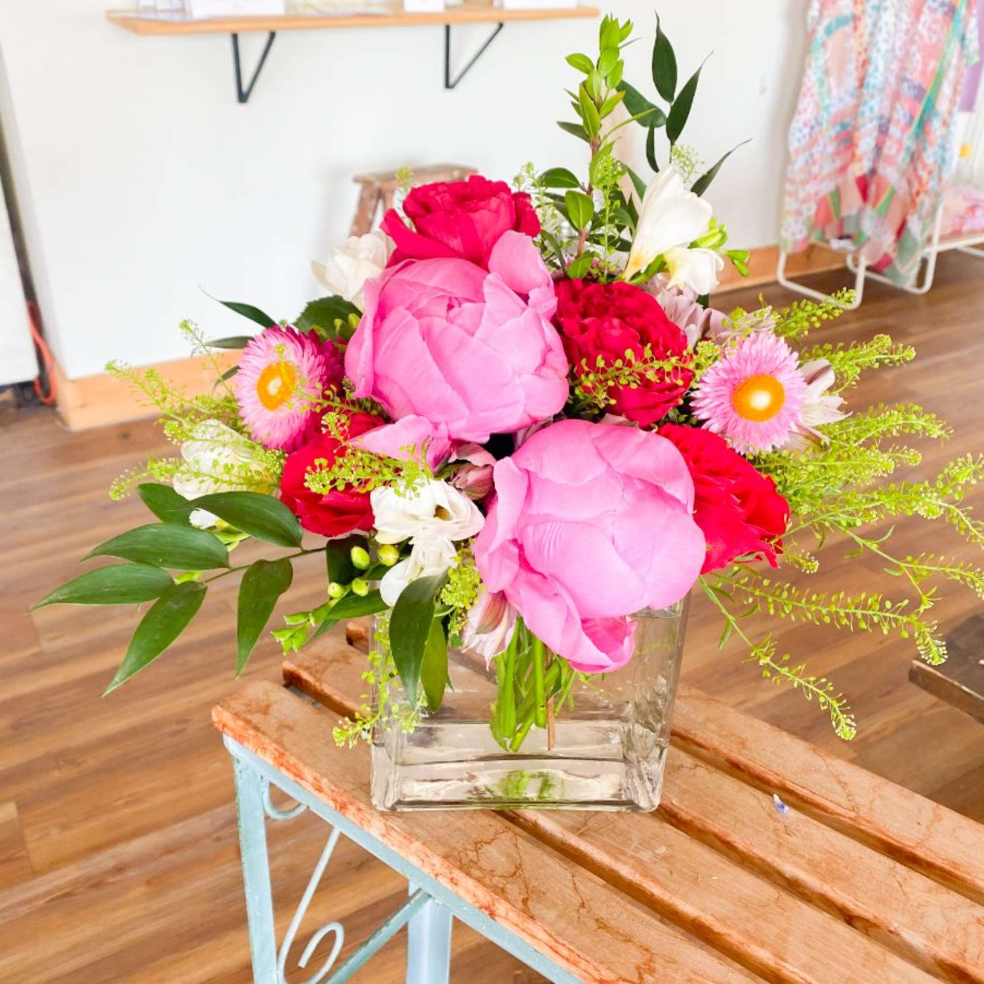 Pink and red flower arrangement in a clear glass vase