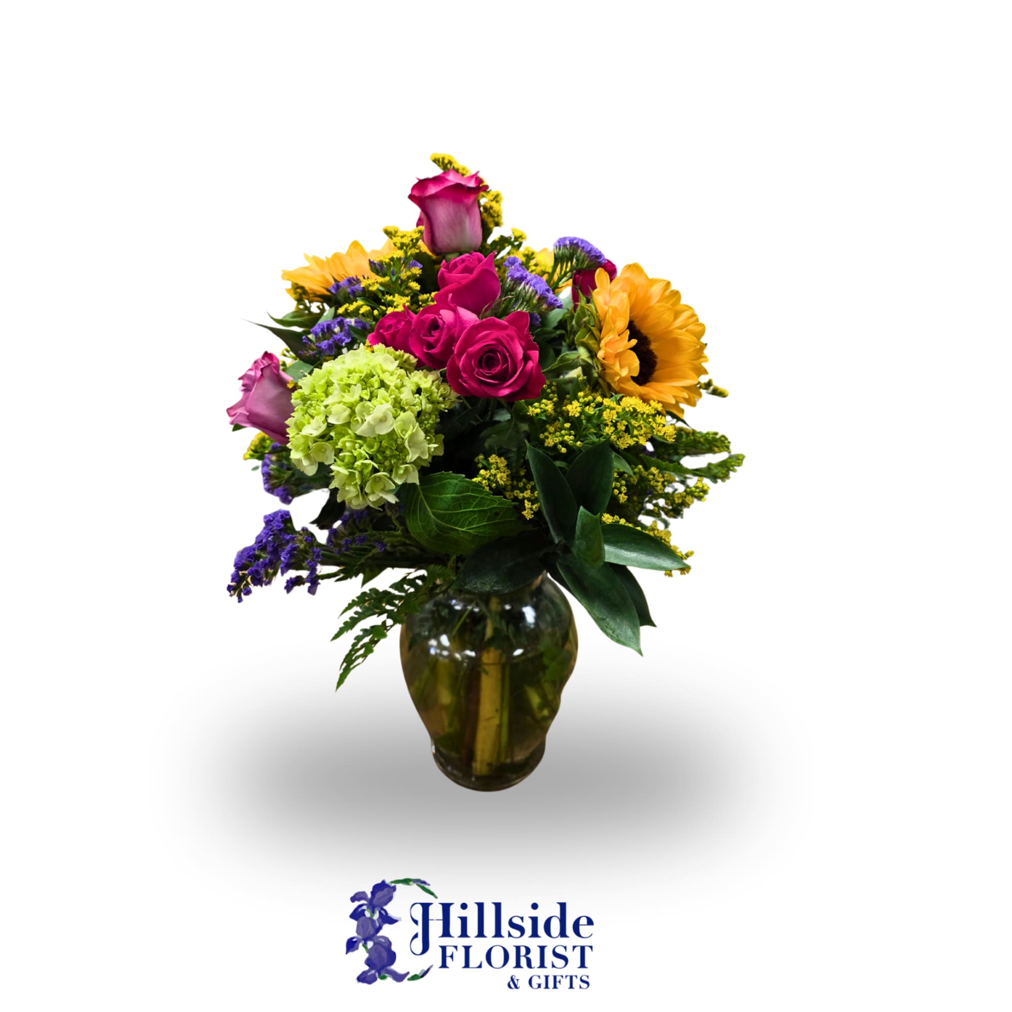 Mixed bouquet in a glass vase with roses, hydrangea, and sunflowers