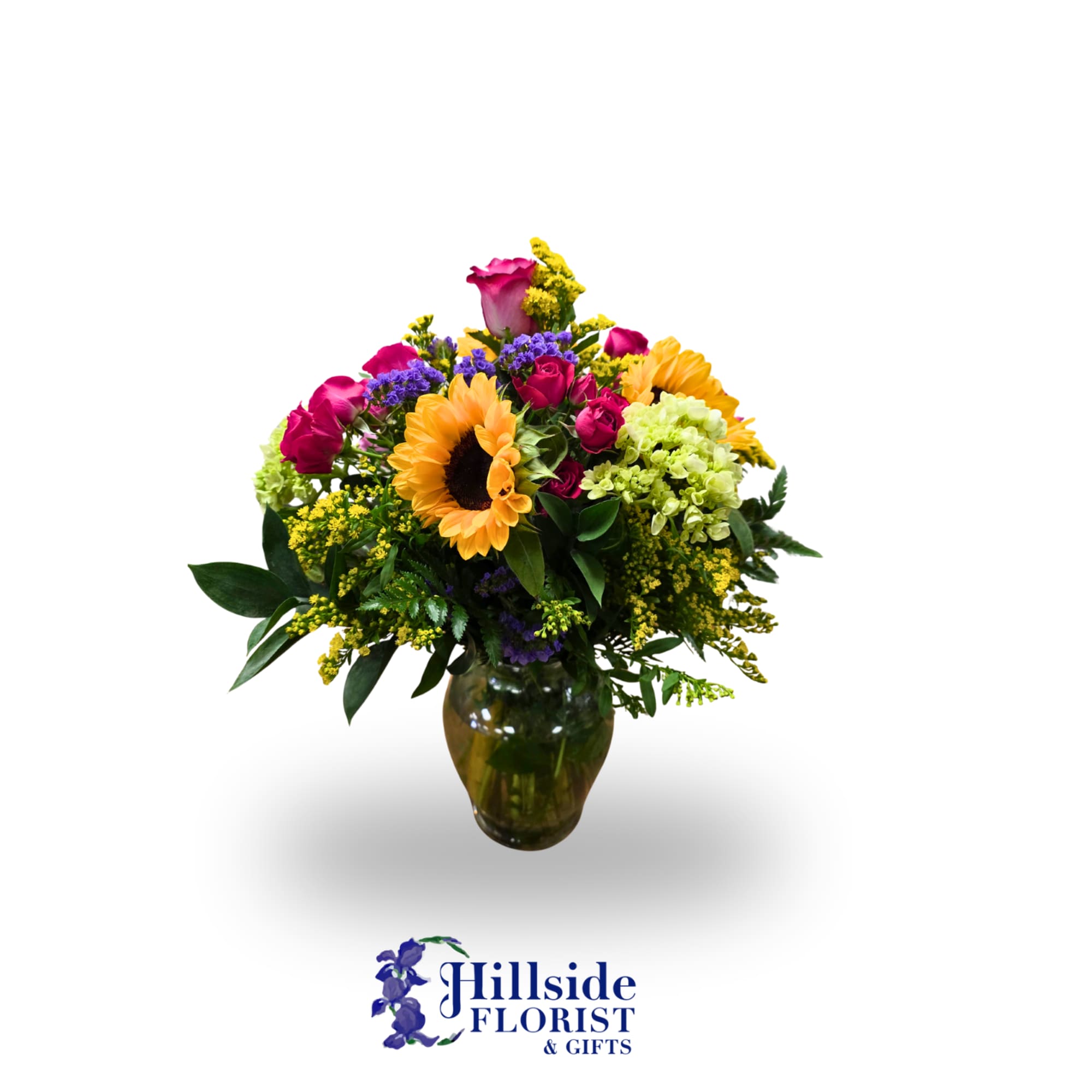 Colorful bouquet of sunflowers and roses in a glass vase
