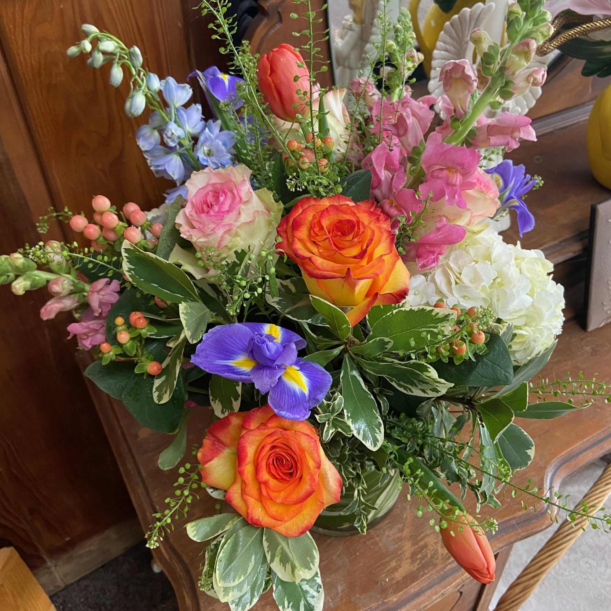 Mix of bright but feminine Spring flowers in 5 x 5 cylinder.