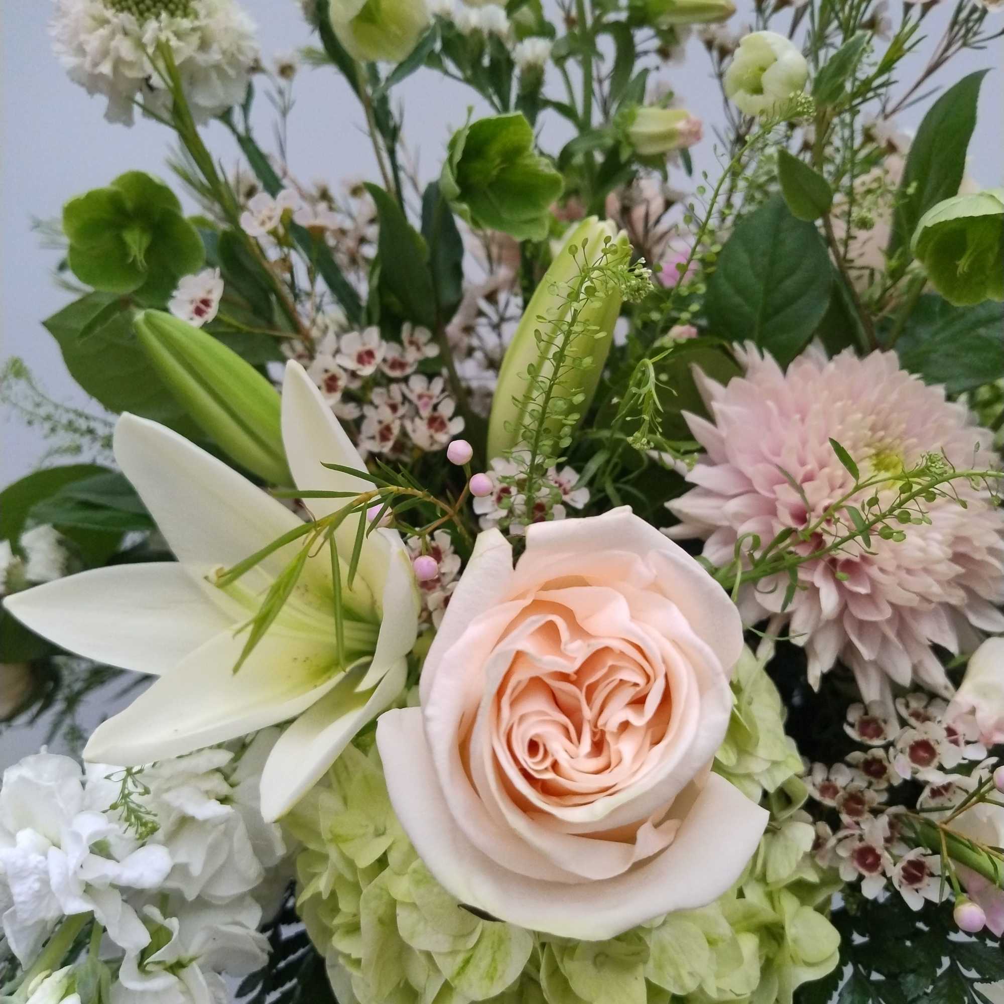 Bouquet with a peach rose, white lily, and pale green hydrangea
