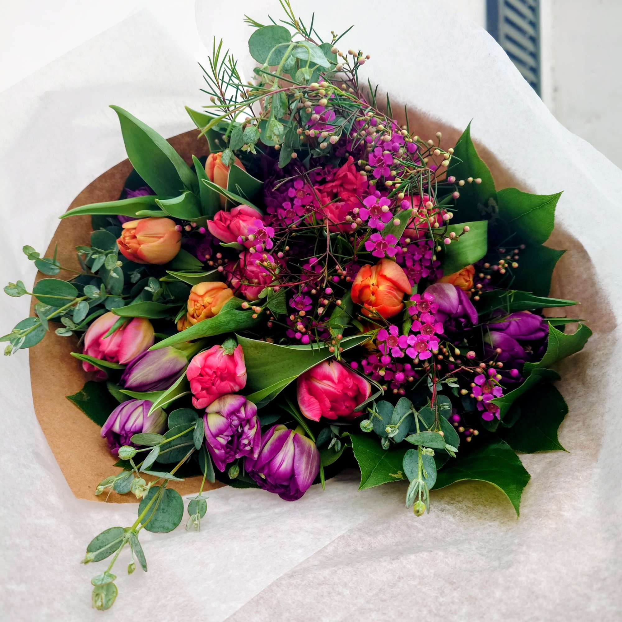 Bouquet of pink and purple tulips with small magenta filler flowers