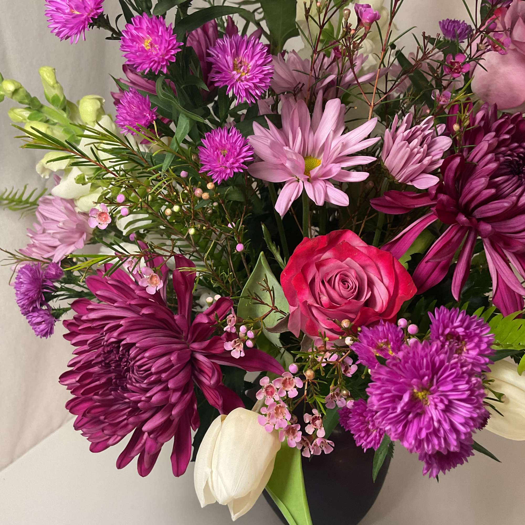 A captivating blend of lavender, purple, and white flowers, elegantly presented in