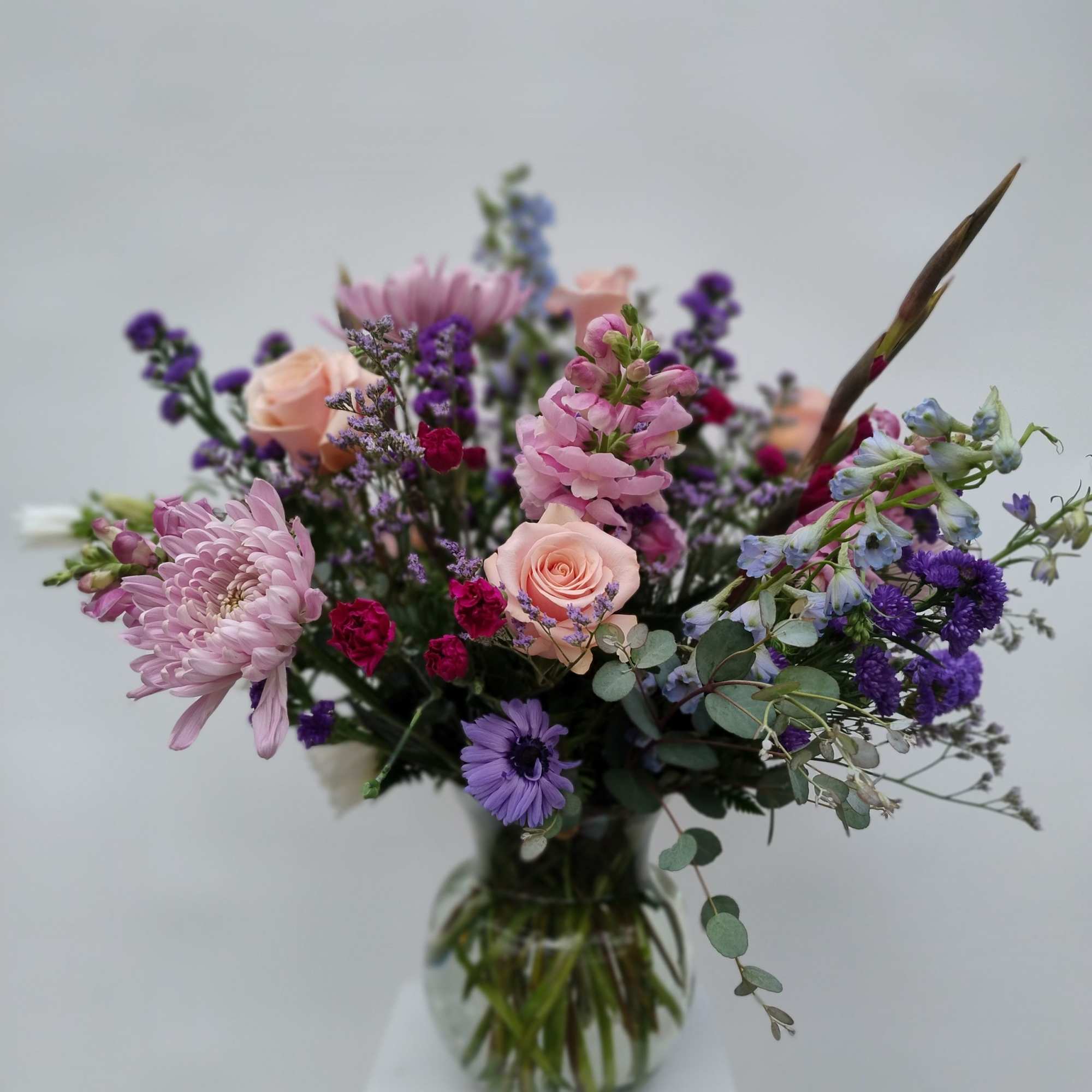 Mixed pink and purple bouquet in a clear glass vase