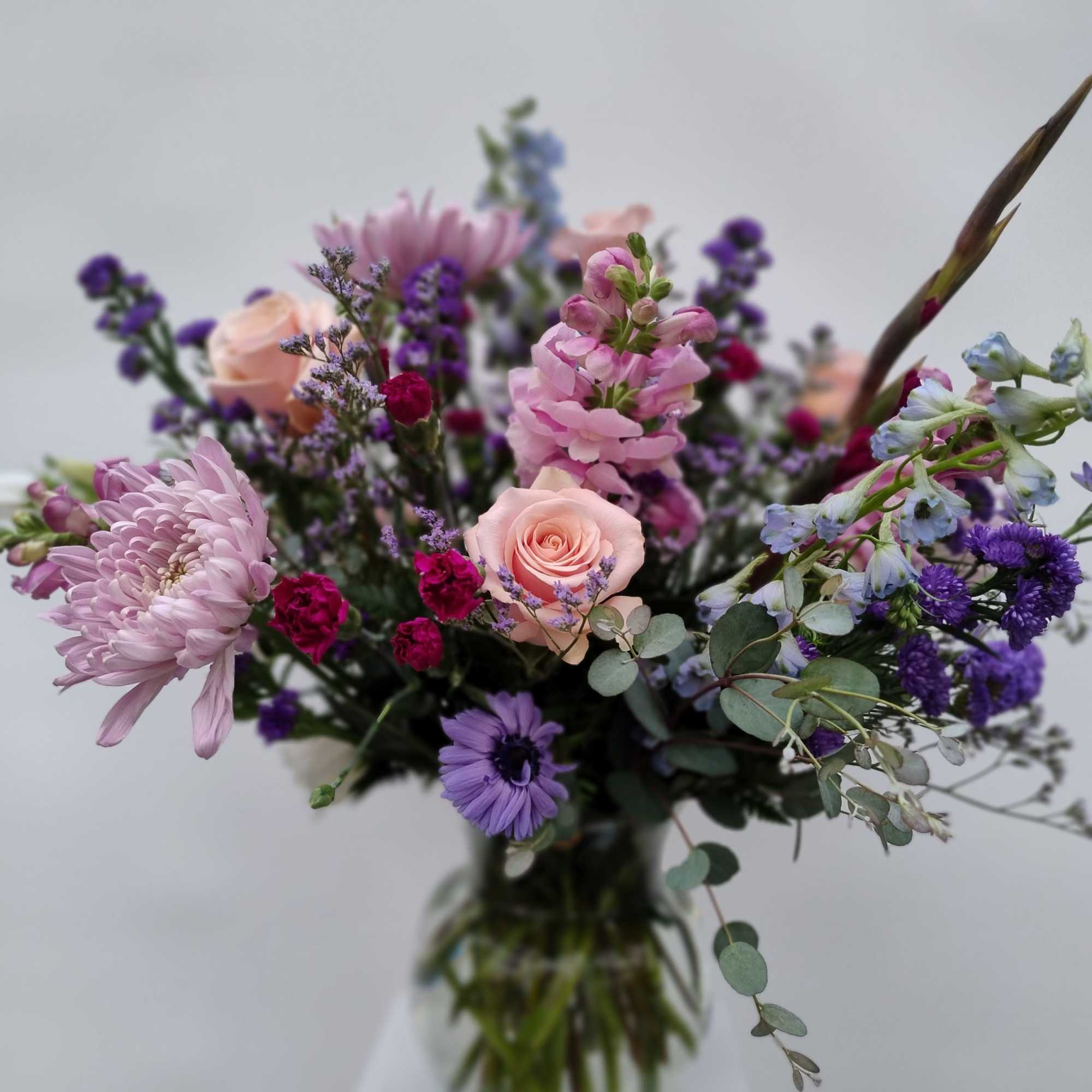 Mixed pink and purple bouquet in a glass vase