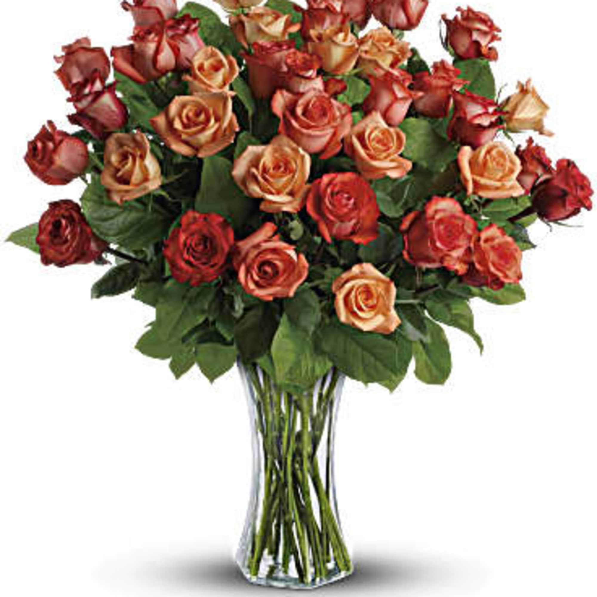 Bouquet of red and peach roses in a clear glass vase