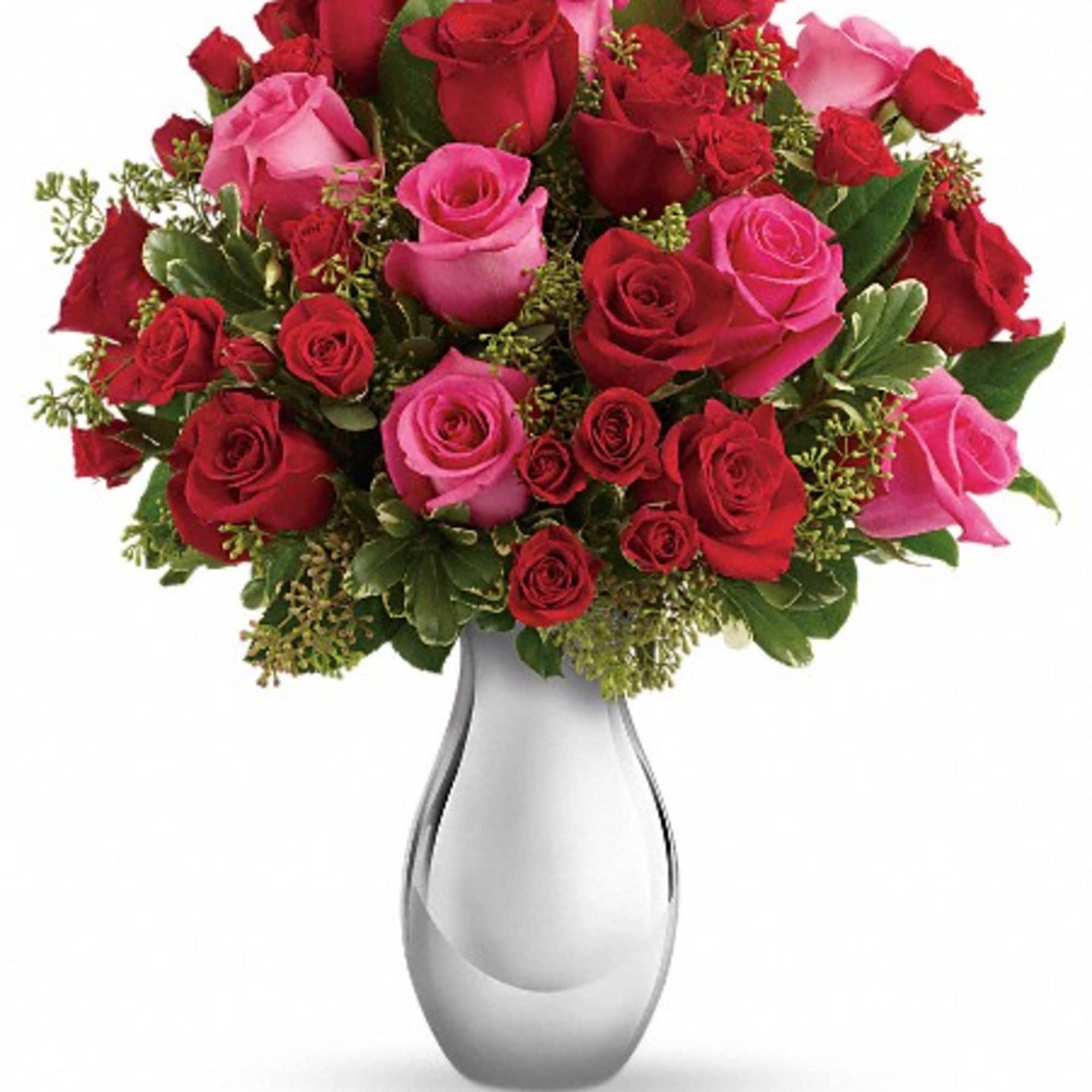 Bouquet of red and pink roses in a clear glass vase