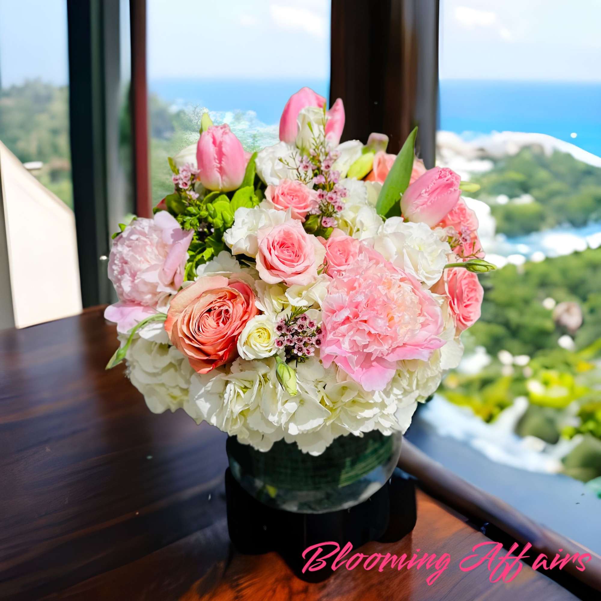 Pink and white mixed flower arrangement in a glass vase