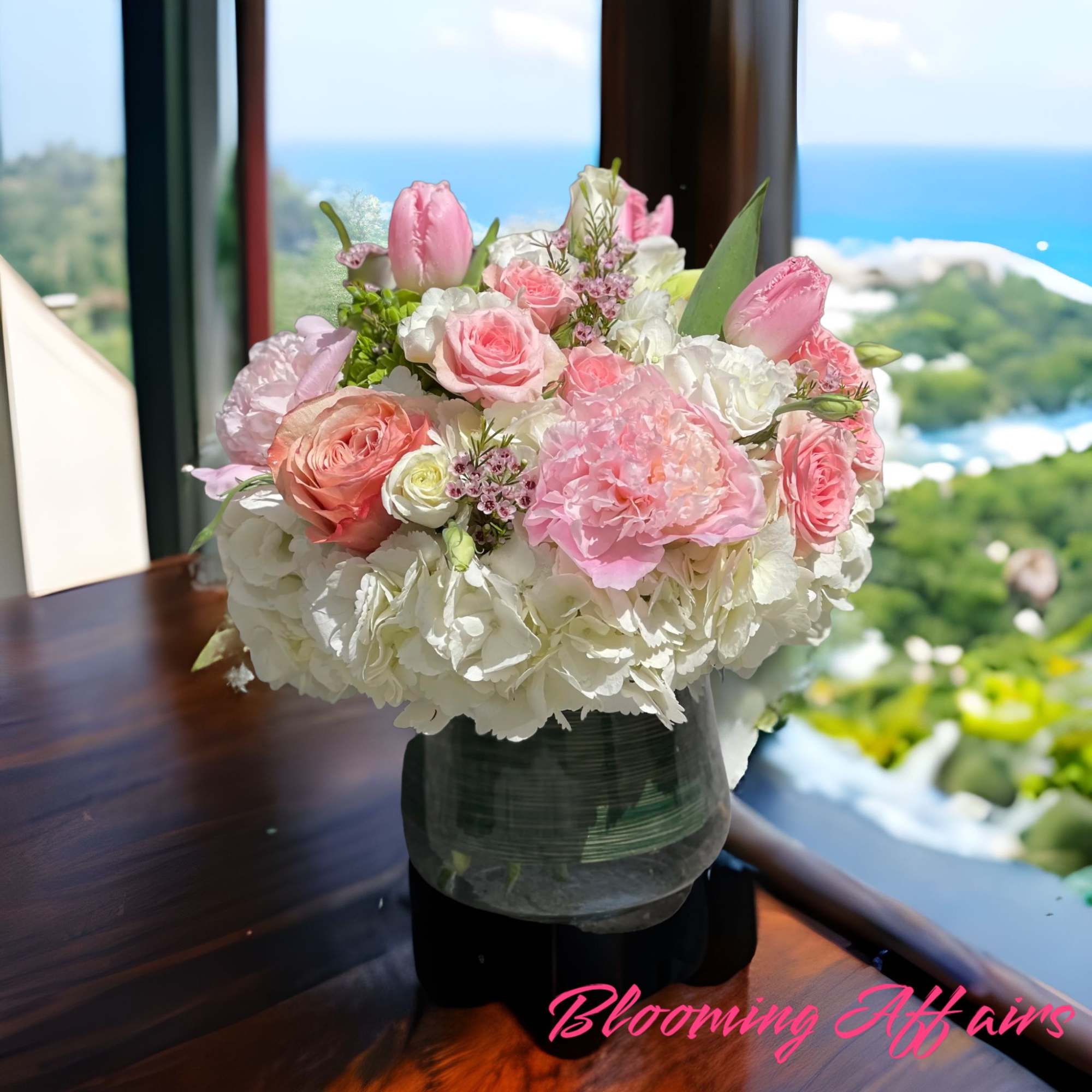 Pink and white floral arrangement in a glass vase
