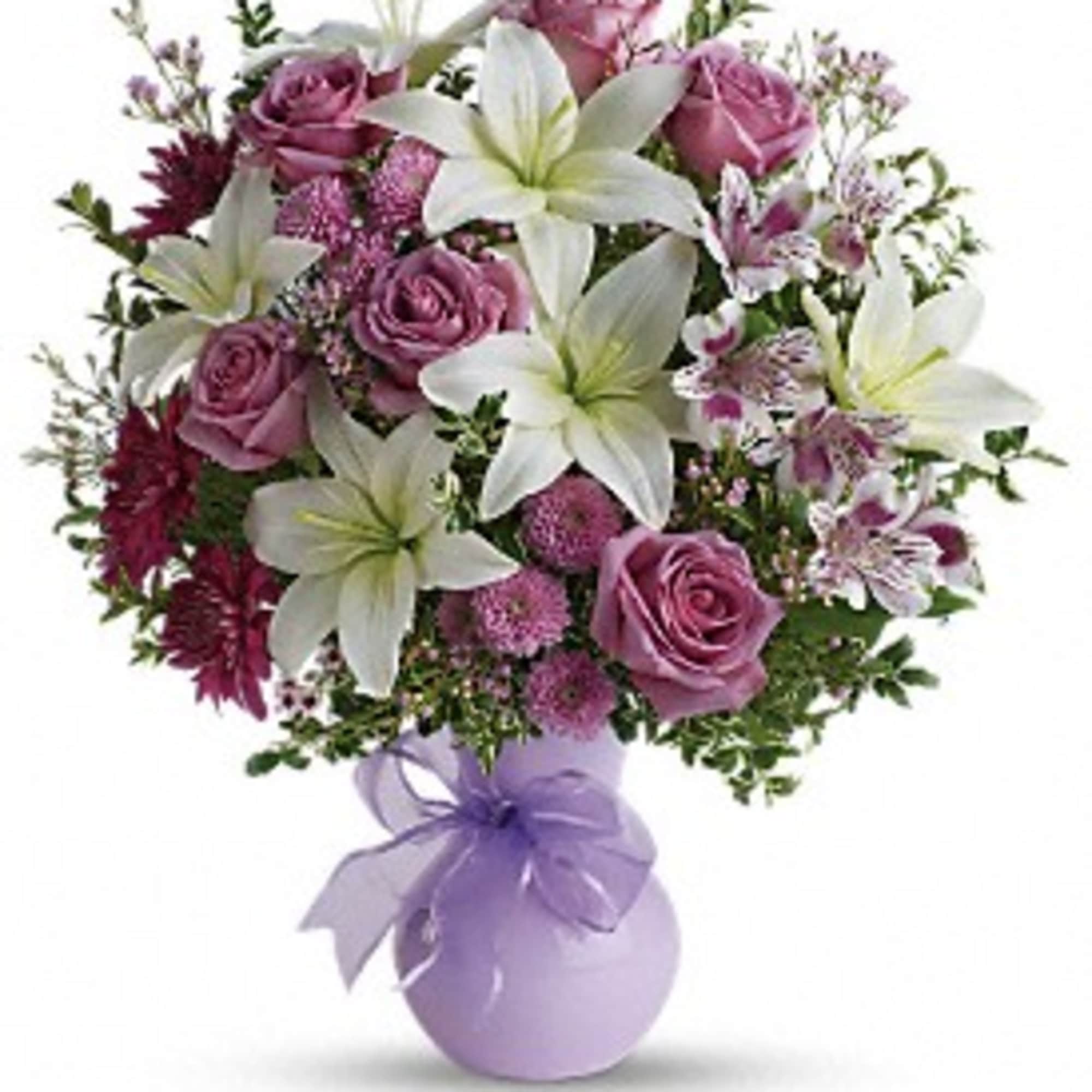 Bouquet of pink roses and white lilies in a lavender vase with a ribbon