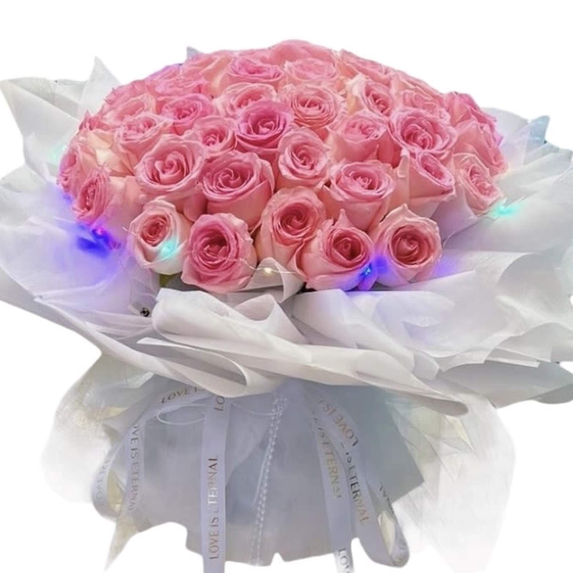 Bouquet of pink roses wrapped in white paper with lights