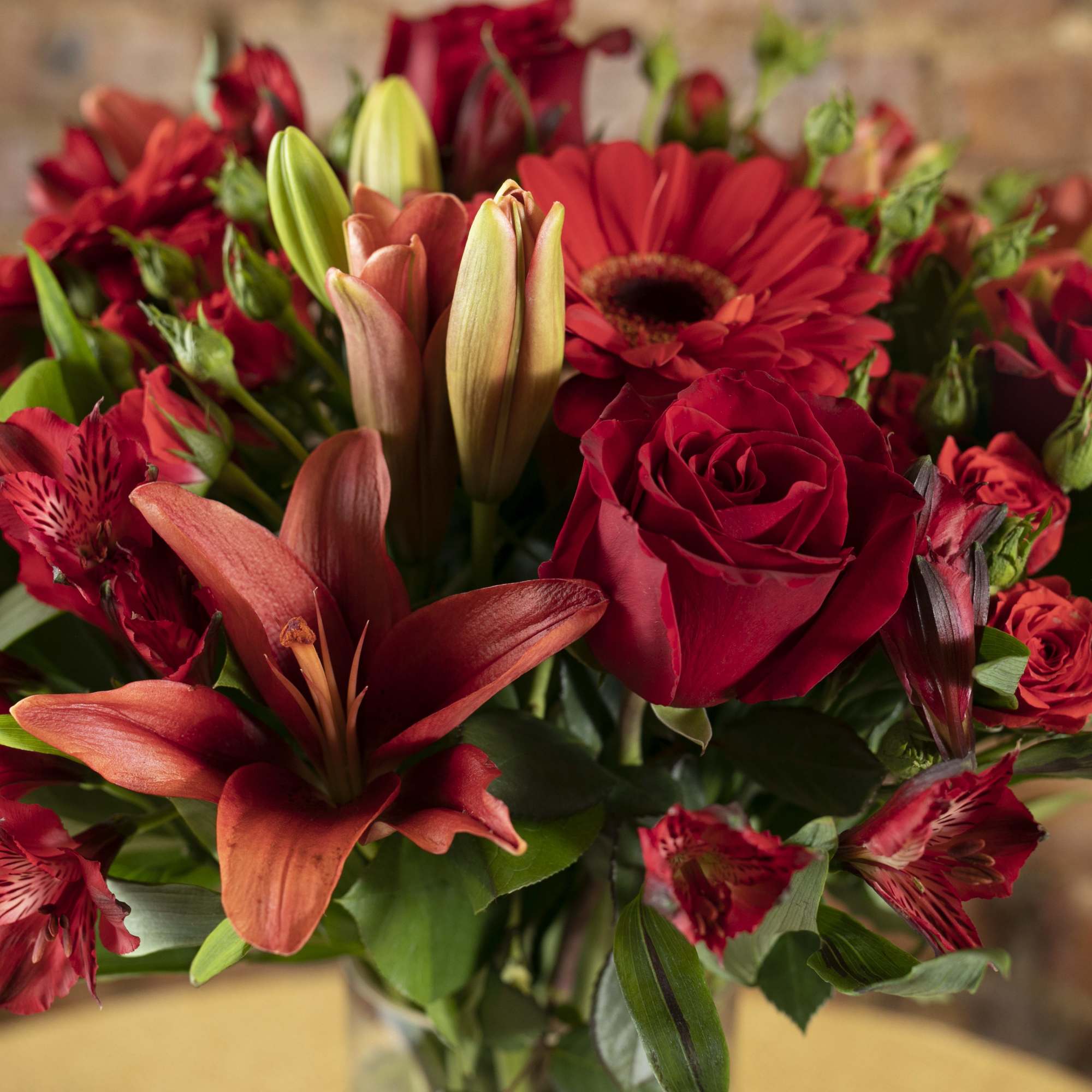 Red roses and lilies arranged in a bouquet