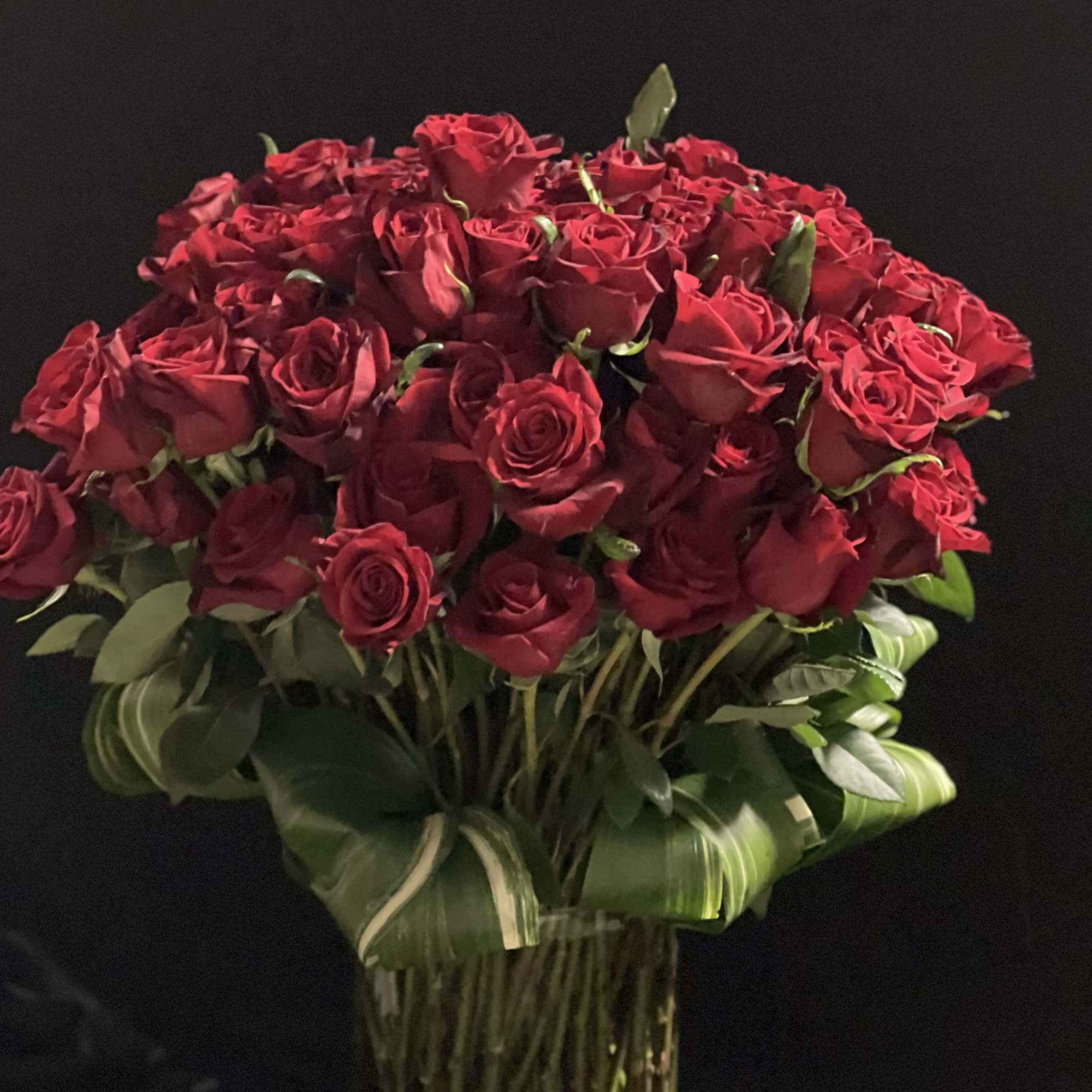 Bouquet of red roses in a clear glass vase