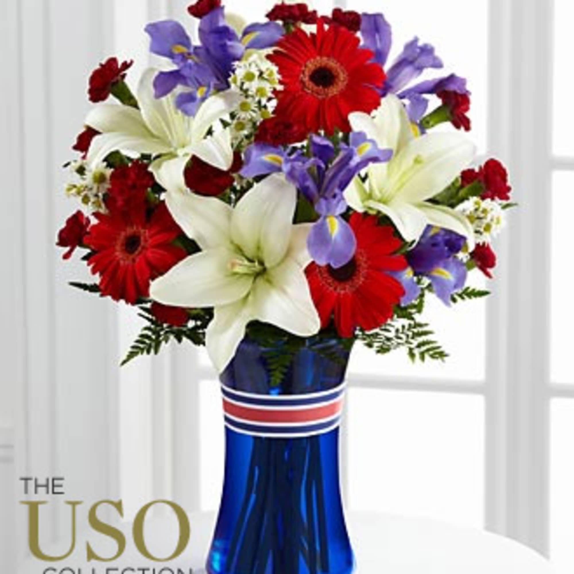 Bouquet of red, white, and purple flowers in a blue vase