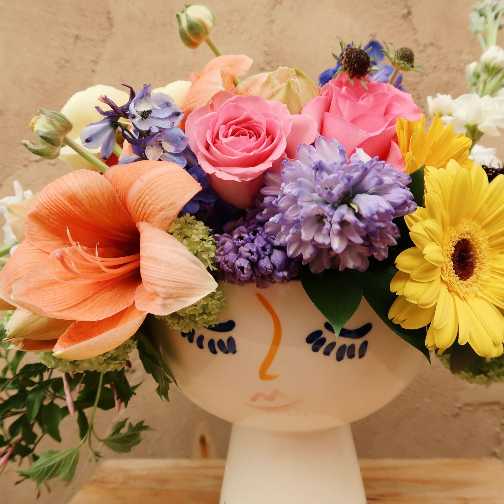 Lola face vase filled with the seasons blooms, bright and beautiful.