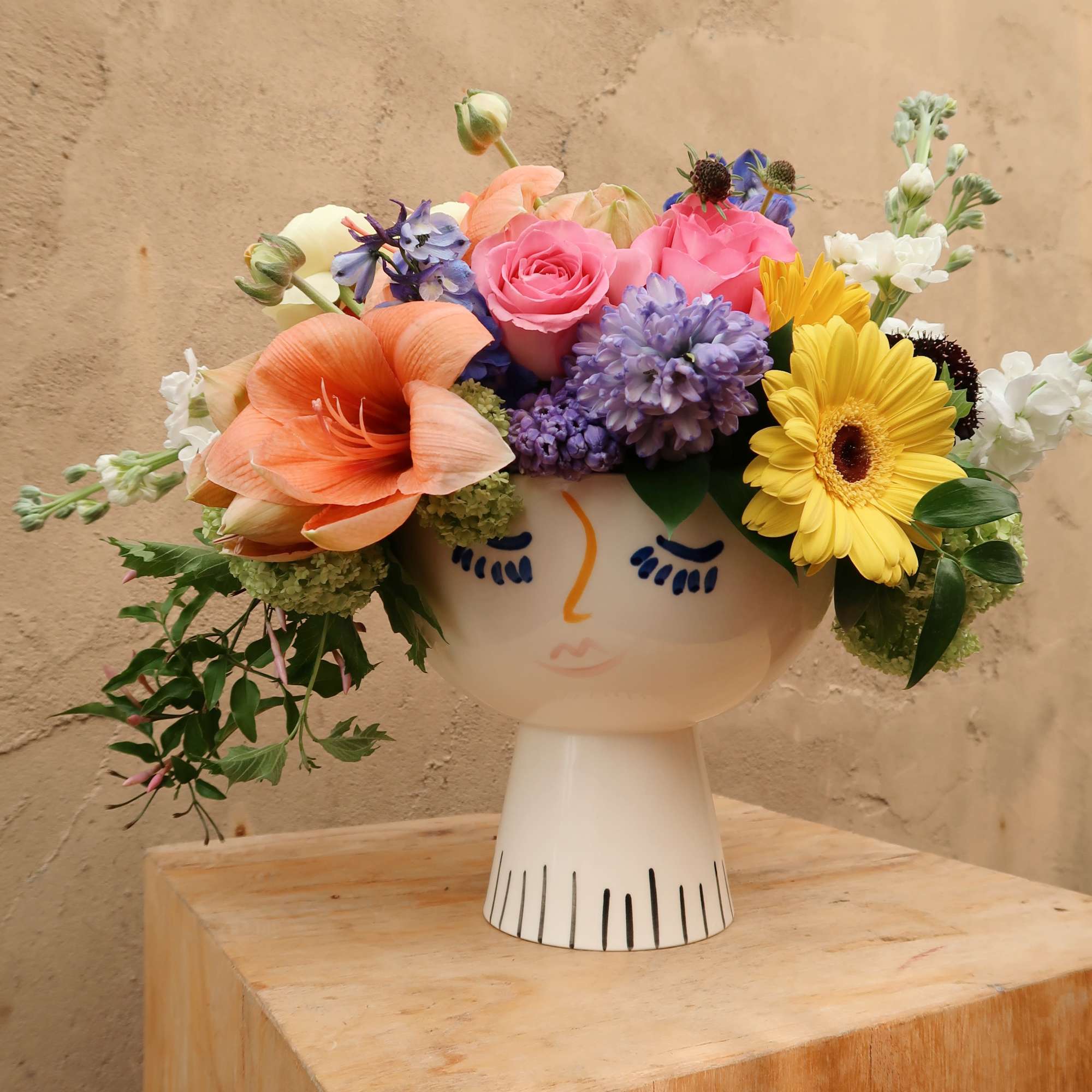 Lola face vase filled with the seasons blooms, bright and beautiful.