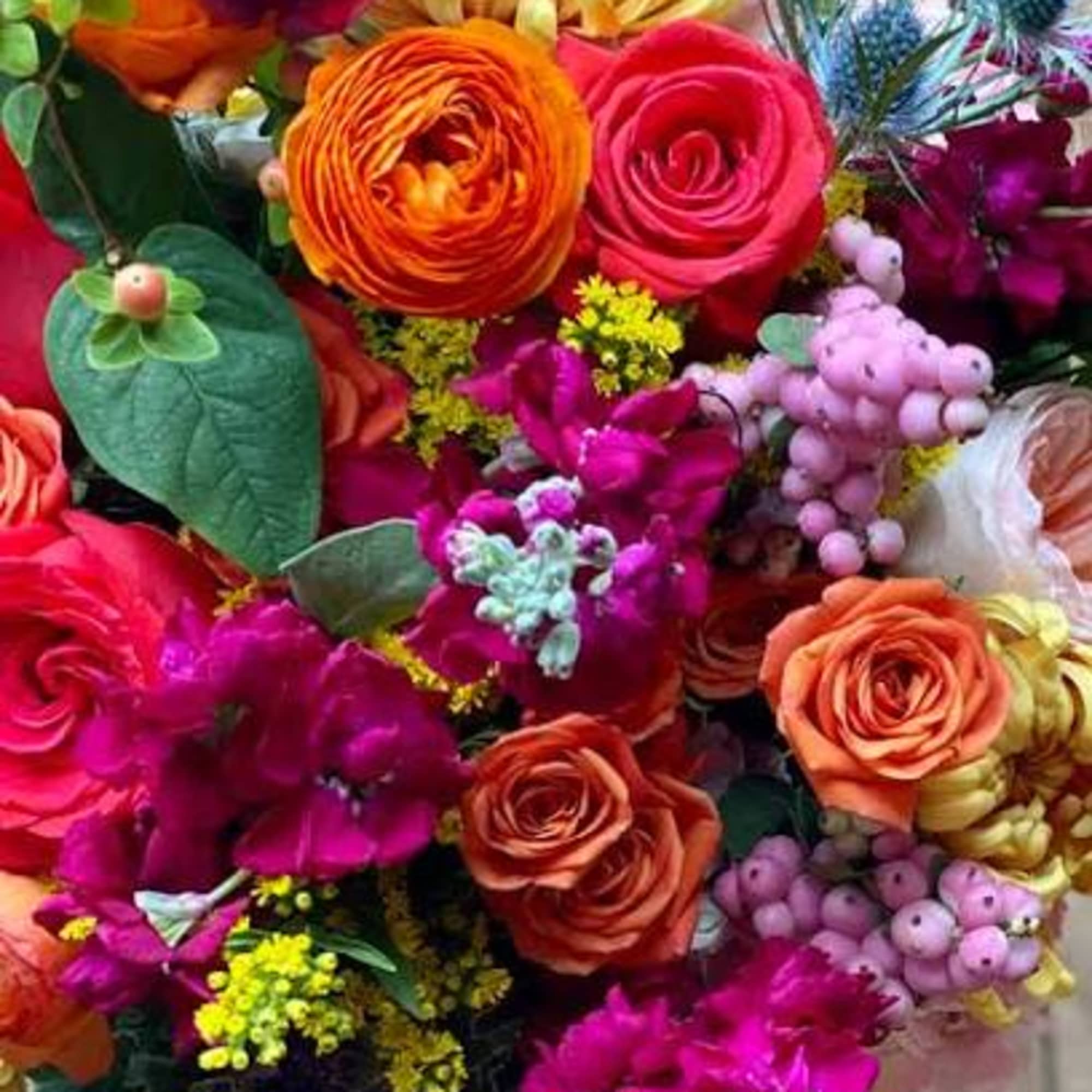 A dense, color-packed mixed bouquet that reads like a celebration in bloom