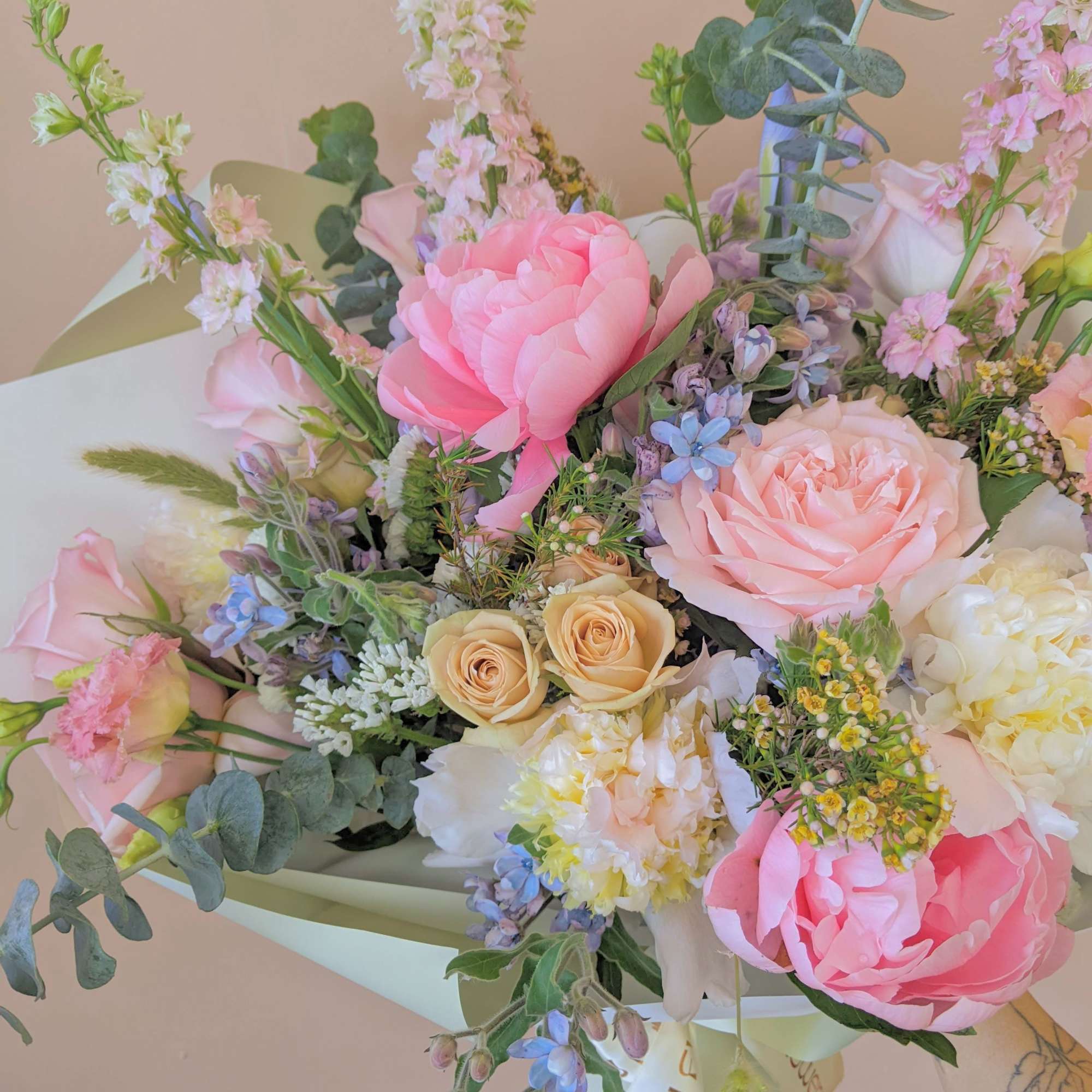 Bouquet of pink and peach roses with mixed pastel flowers