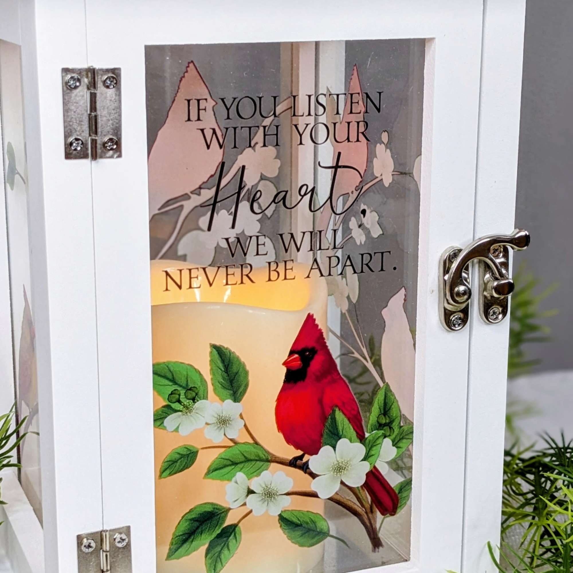 White lantern with a candle and cardinal design