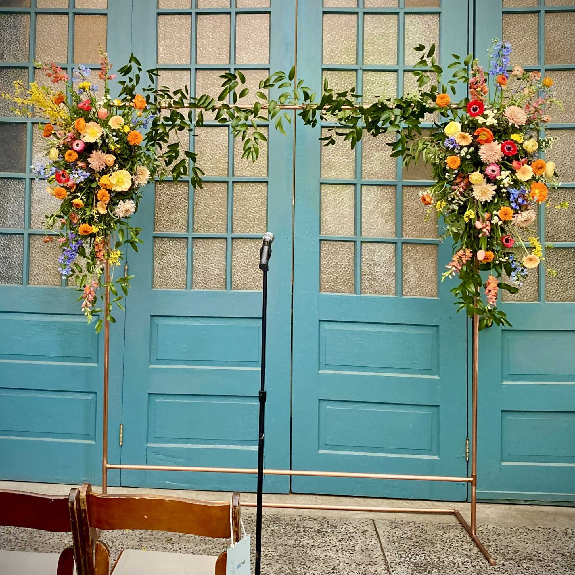 A large arrangement for ceremony arch could be placed on a corner