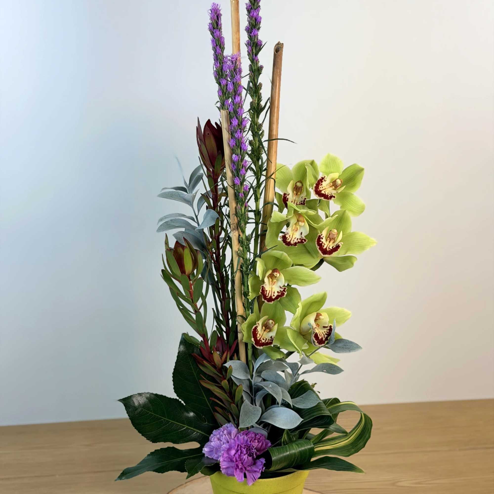 Featuring the stunning Cymbidium Orchid, this stylish arrangement is sure to bring