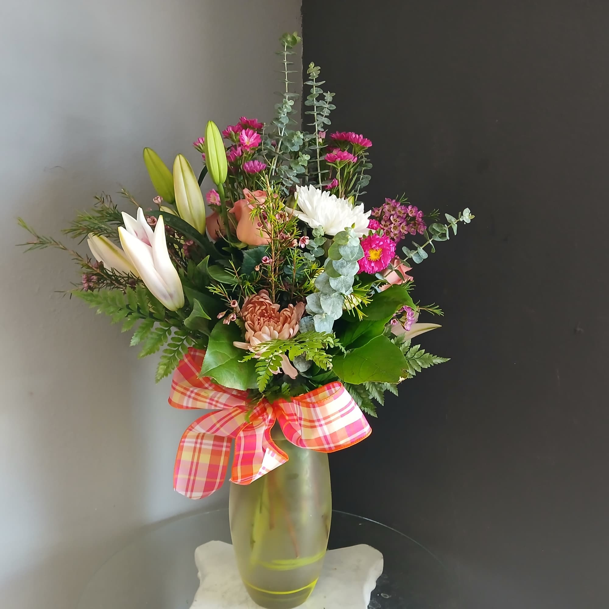 This beautiful flower arrangement of fresh mixed seasonal blooms is made by