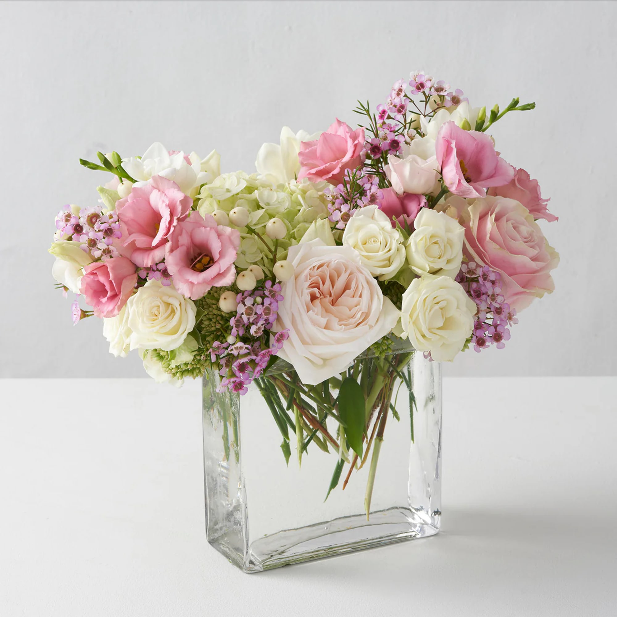 Pink and white mixed bouquet in a clear glass vase