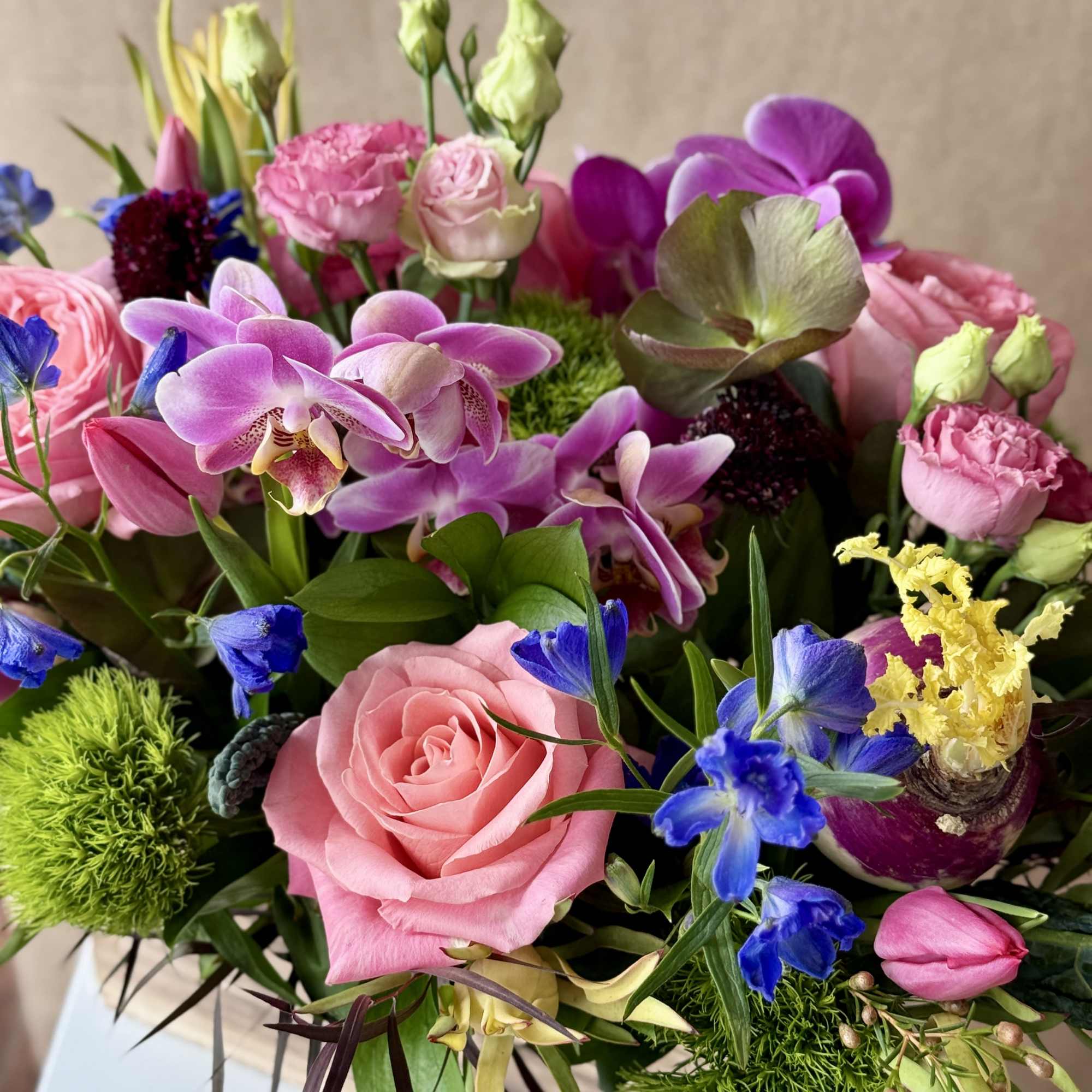 Mixed bouquet with pink roses, purple orchids, and blue flowers