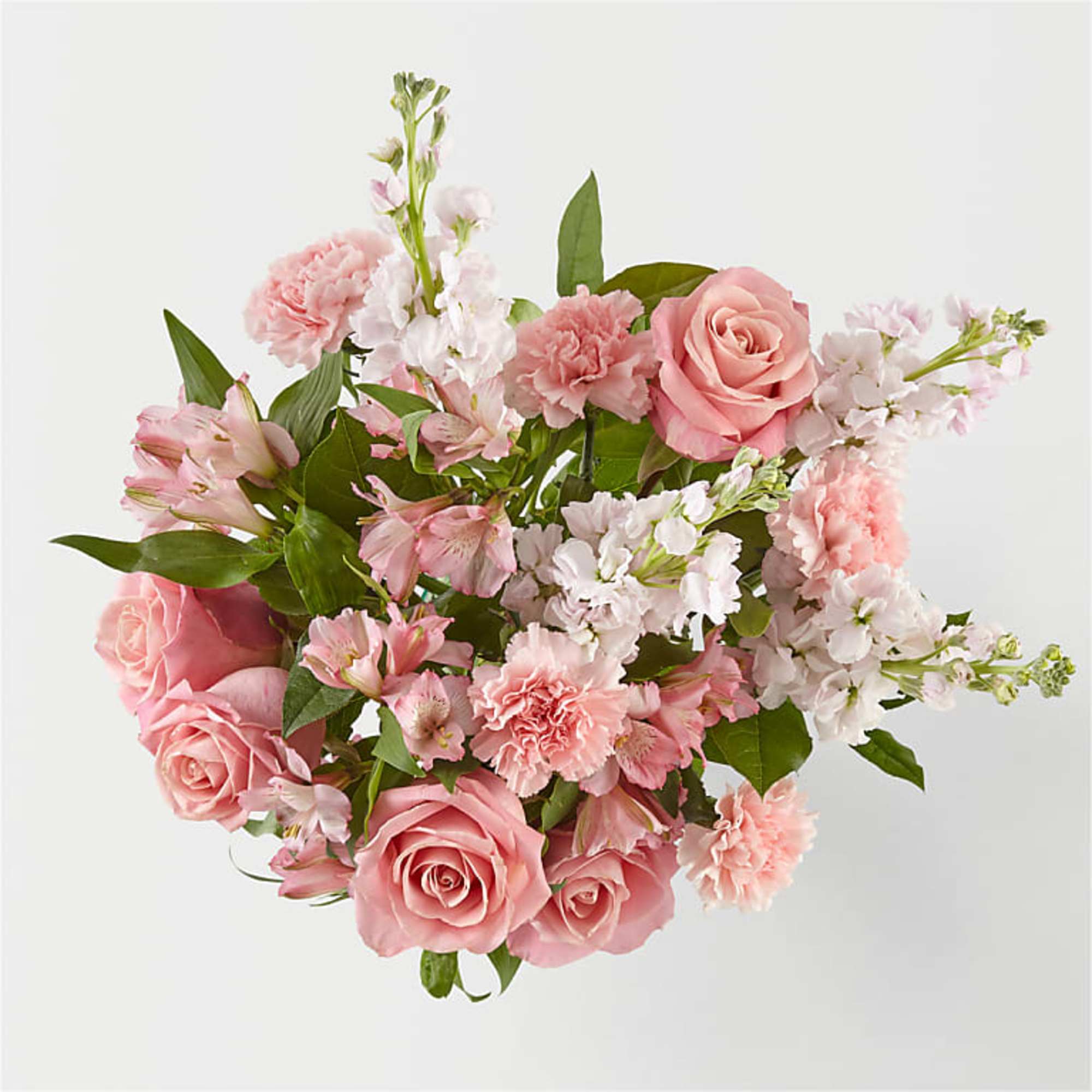 Pink roses and carnations arranged with white blossoms