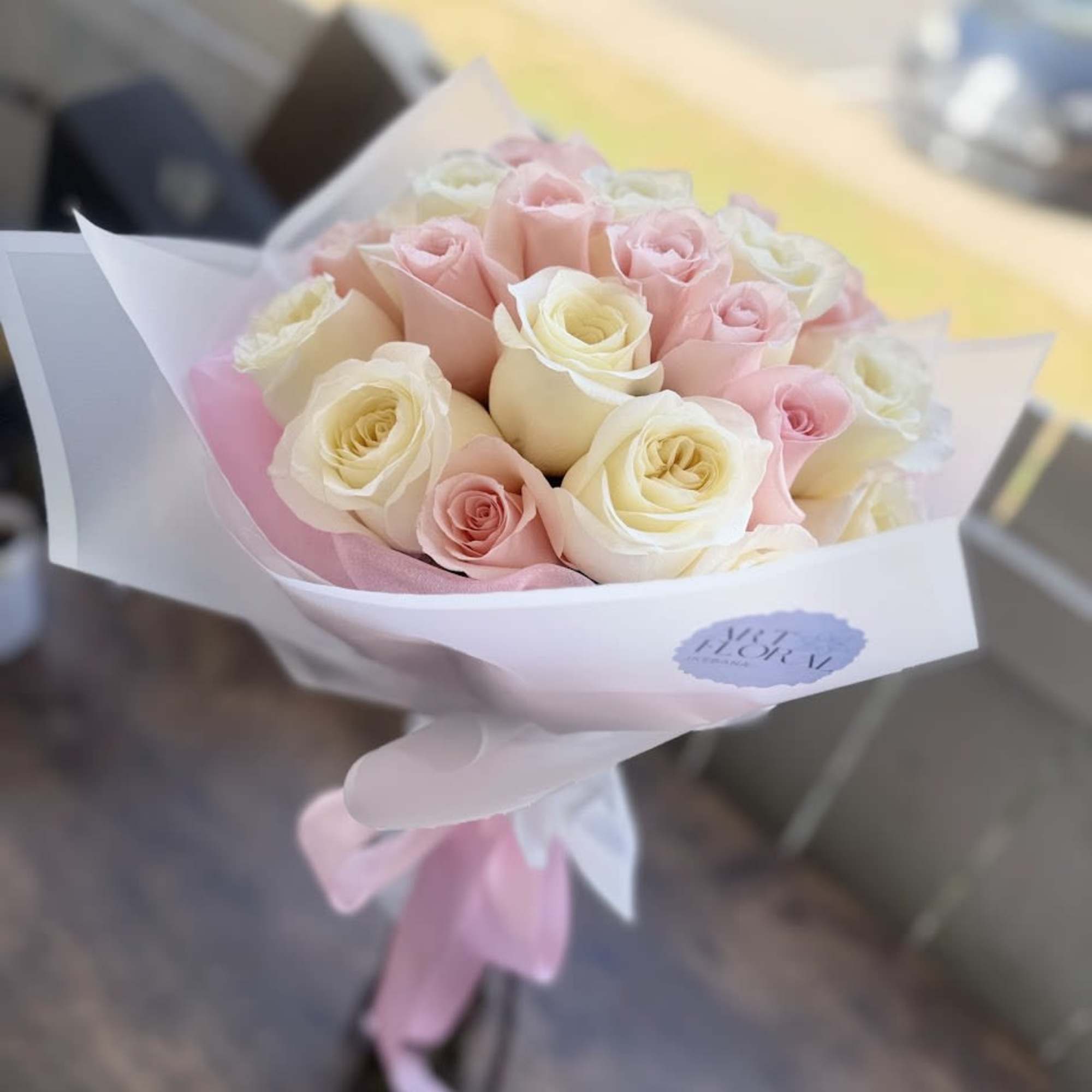 A graceful bouquet featuring delicate white and pink roses, thoughtfully arranged to