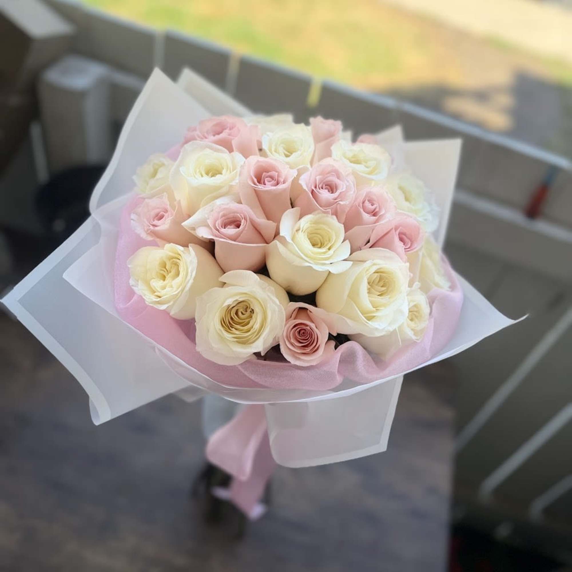 A graceful bouquet featuring delicate white and pink roses, thoughtfully arranged to